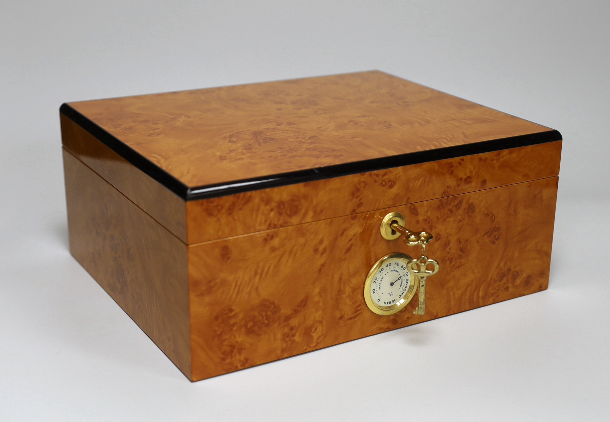 A thuya wood humidor with key, 12.5cm high x 29cm wide                                                                                                                                                                      