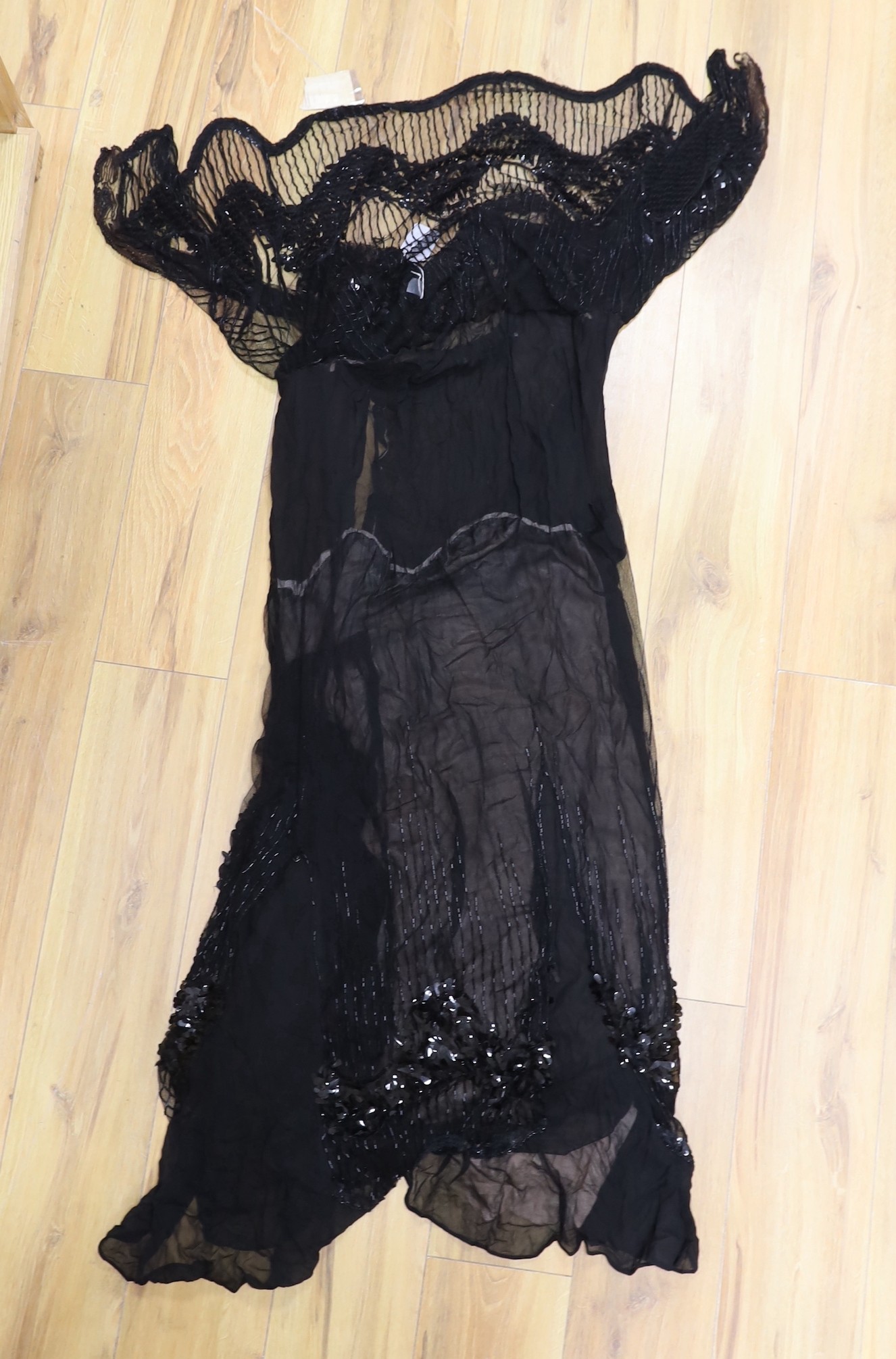 An early 20th century ladies black silk net and chiffon, beaded and sequin evening dress                                                                                                                                    