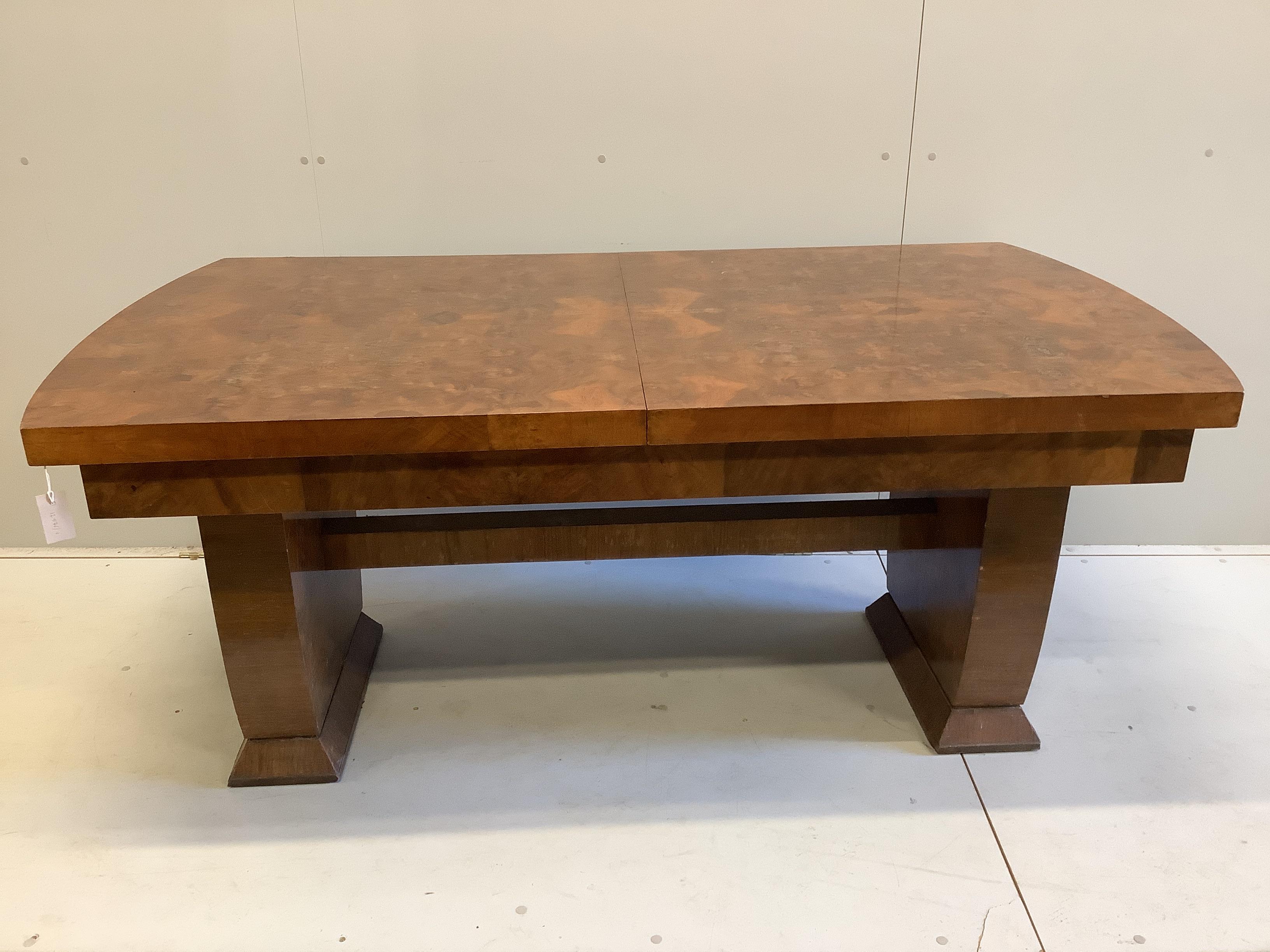An Art Deco style walnut extending dining table, width 170cm, depth 92cm, height 73cm                                                                                                                                       