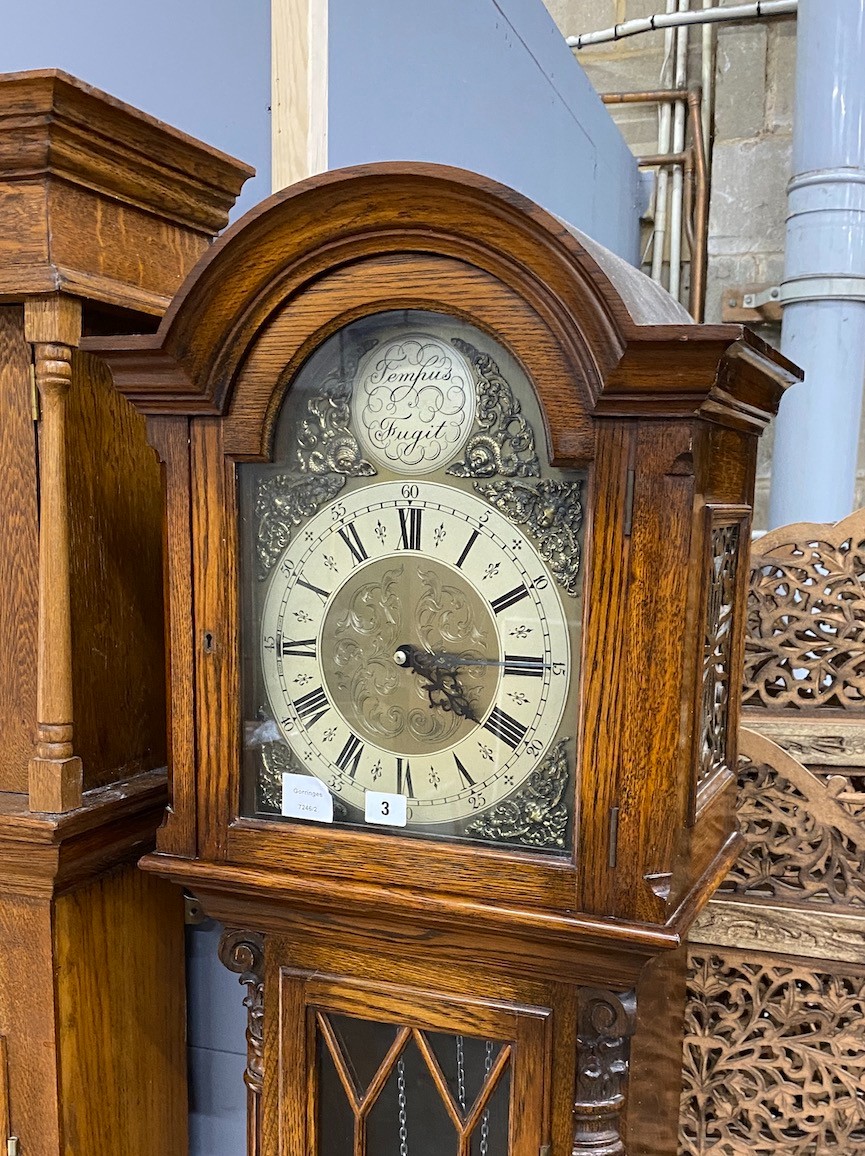 A modern oak longcase clock, with "Tempus Fugit" in the arch, height 195cm                                                                                                                                                  