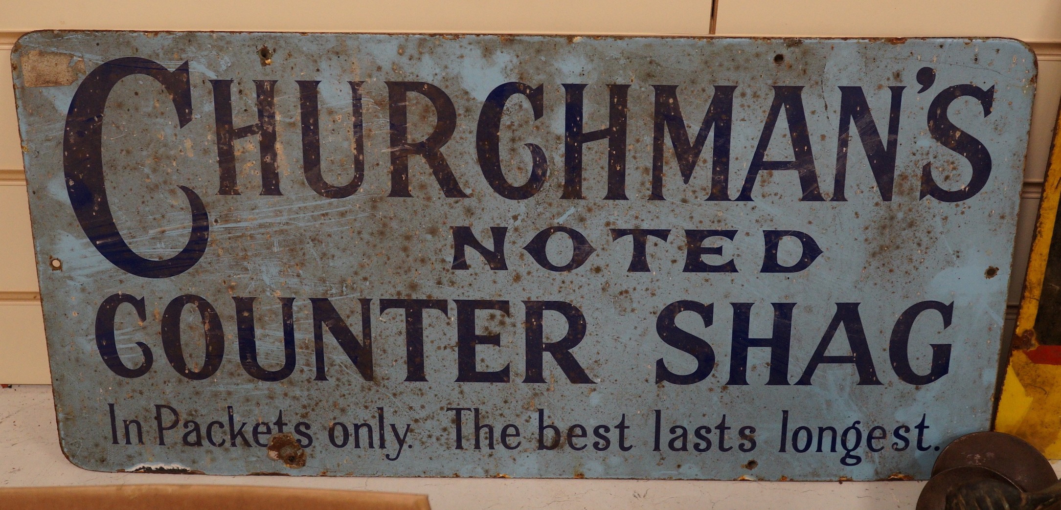 A Churchman's Noted Counter Shag enamel advertising sign, 30x60cm                                                                                                                                                           