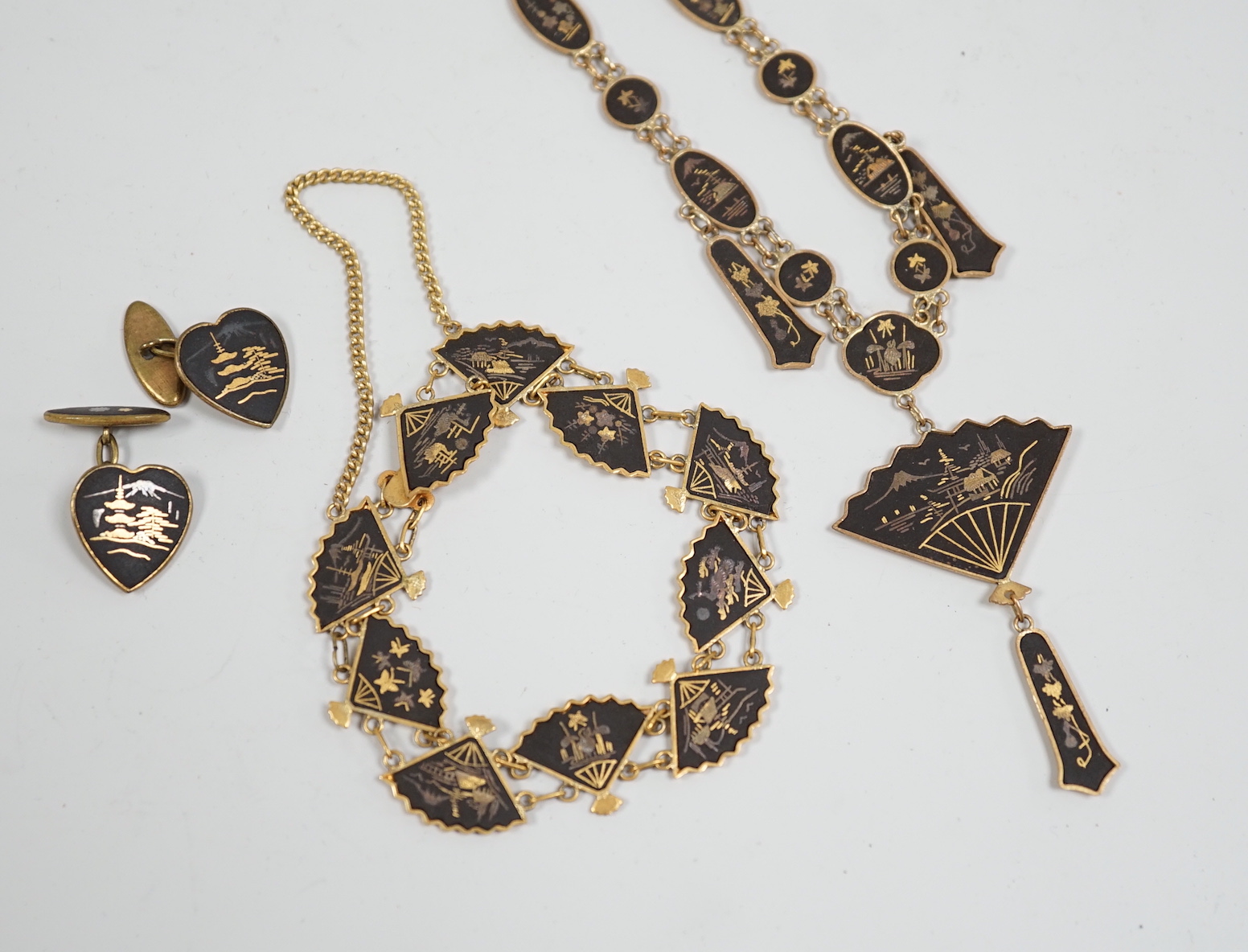 A Japanese gilt damascened iron work suite of jewellery: necklace, bracelet and a pair of cuff links                                                                                                                        