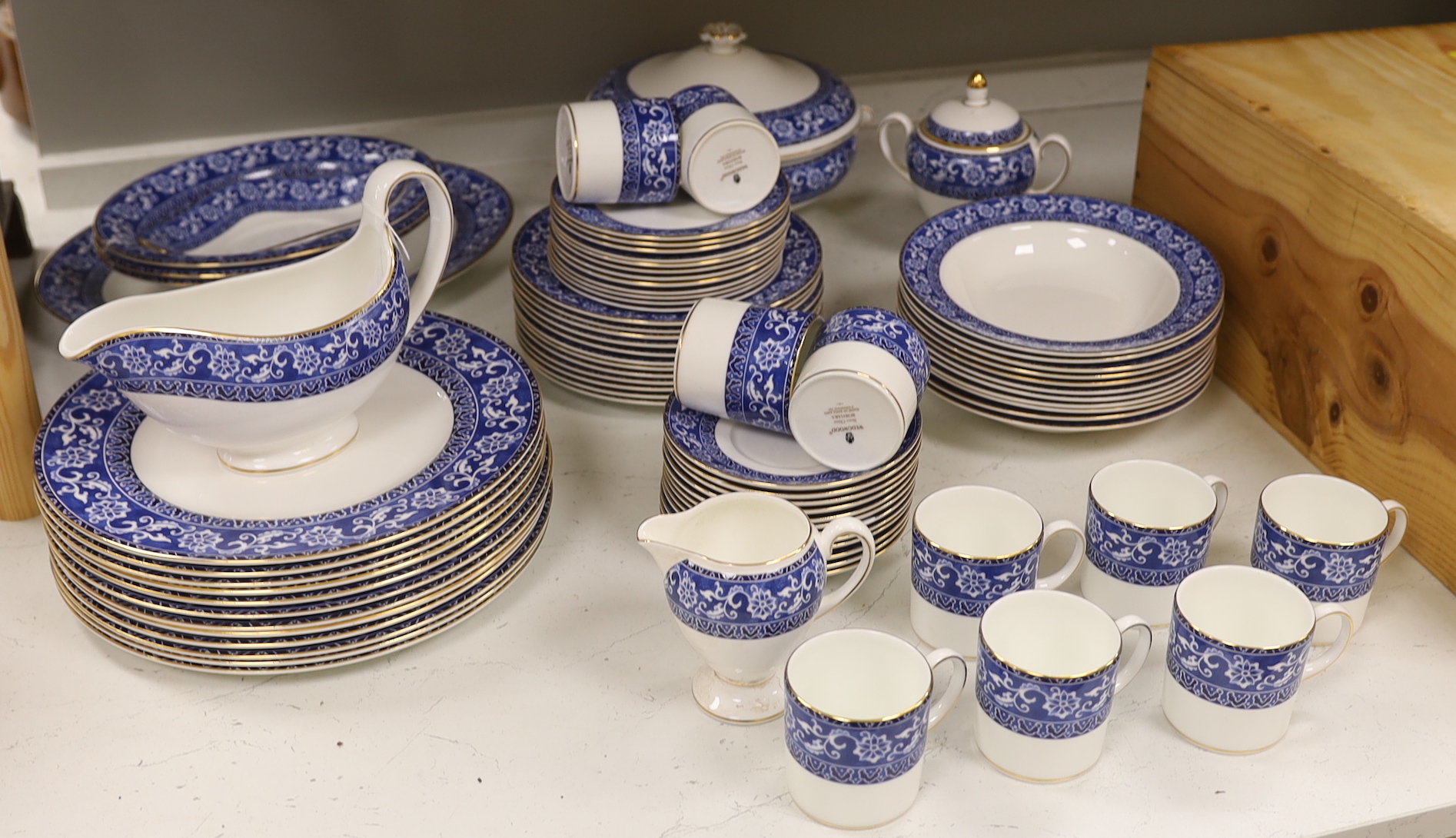 A Wedgwood Bokhara pattern 55 piece part dinner service, including a lidded vegetable tureen, a lidded sugar bowl, a cream jug, 12 dinner plates, 12 side plates, 12 dessert plates, 11 soup bowls, 3 pudding bowls and 2 ov