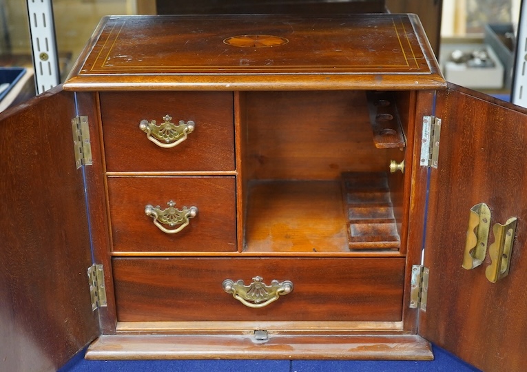 An Edwardian mahogany inlay two door smoker's cabinet, 30.5cm high, 35.5cm wide. Condition - fair                                                                                                                           