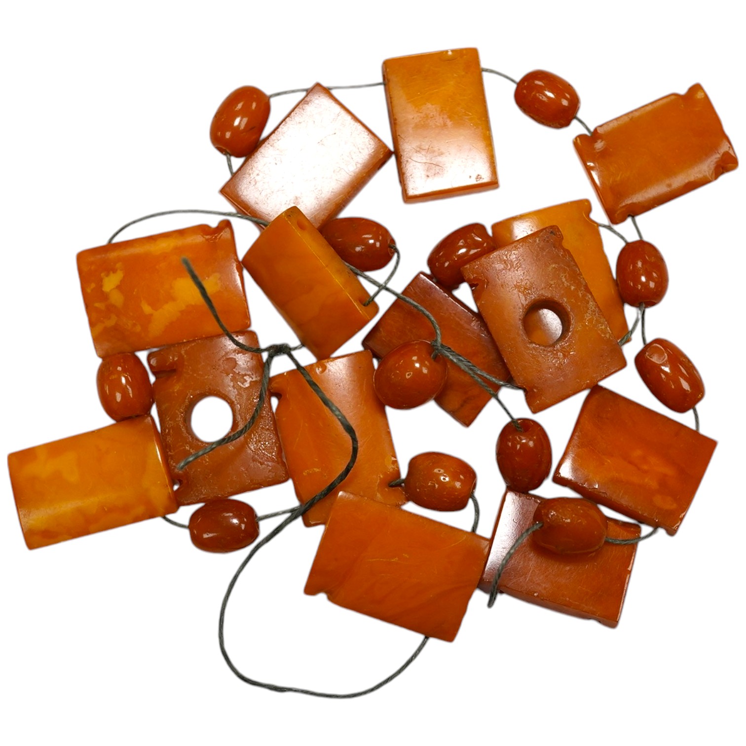 A small group of assorted shaped amber beads, gross weight 26 grams. Condition - poor to fair                                                                                                                               