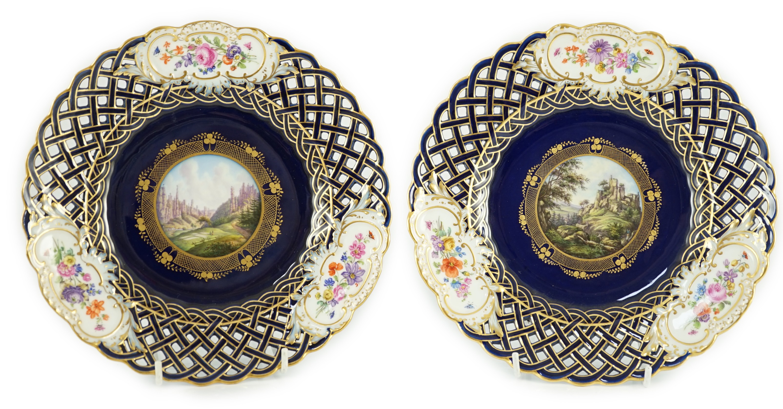 A pair of Meissen reticulated named view plates, 19th century, 23.7cm diameter                                                                                                                                              