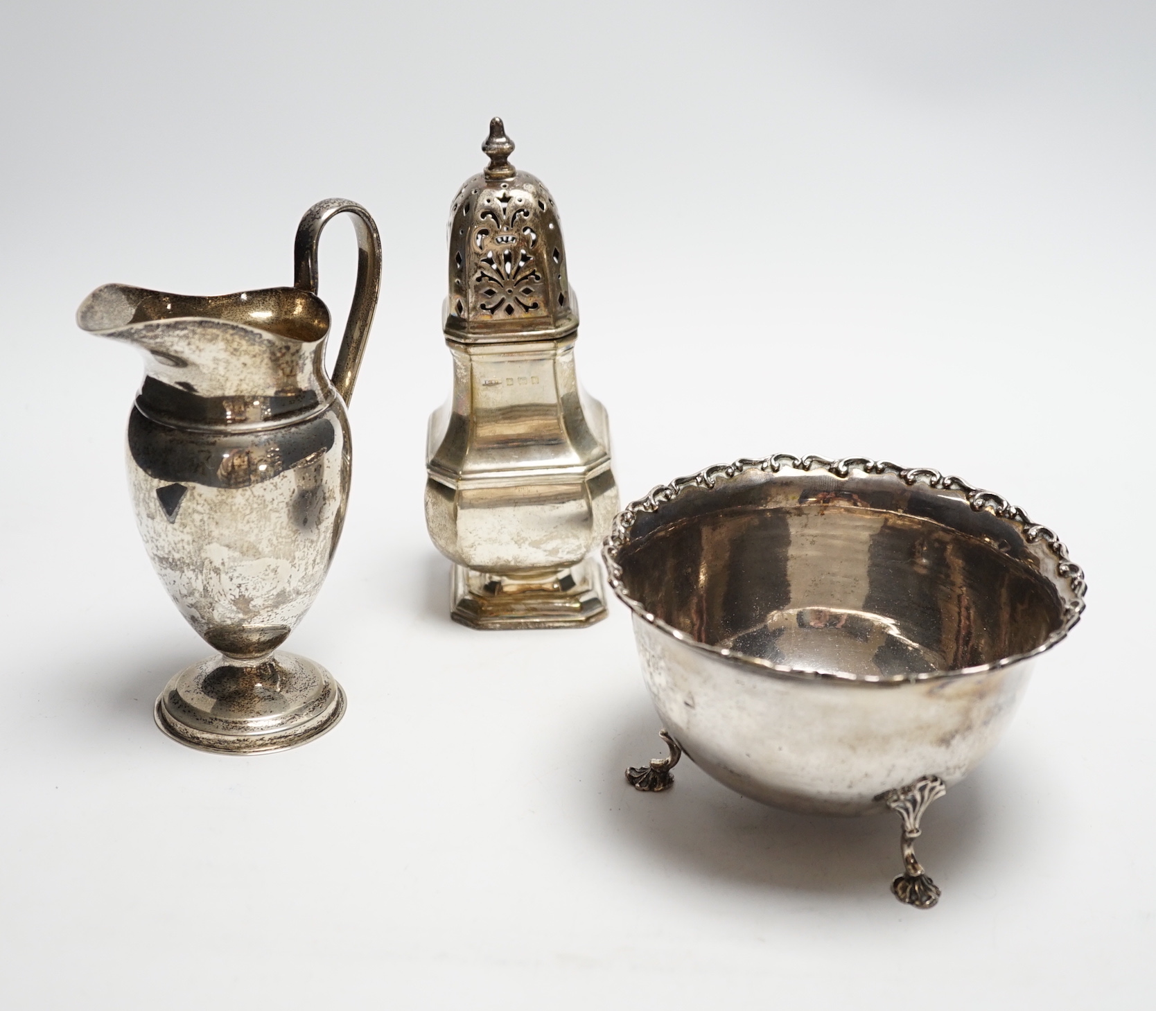 A late Victorian silver cream jug, William & John Barnard, London 1899, 14,7cm, together with a silver bowl and sugar caster, 16oz.                                                                                         