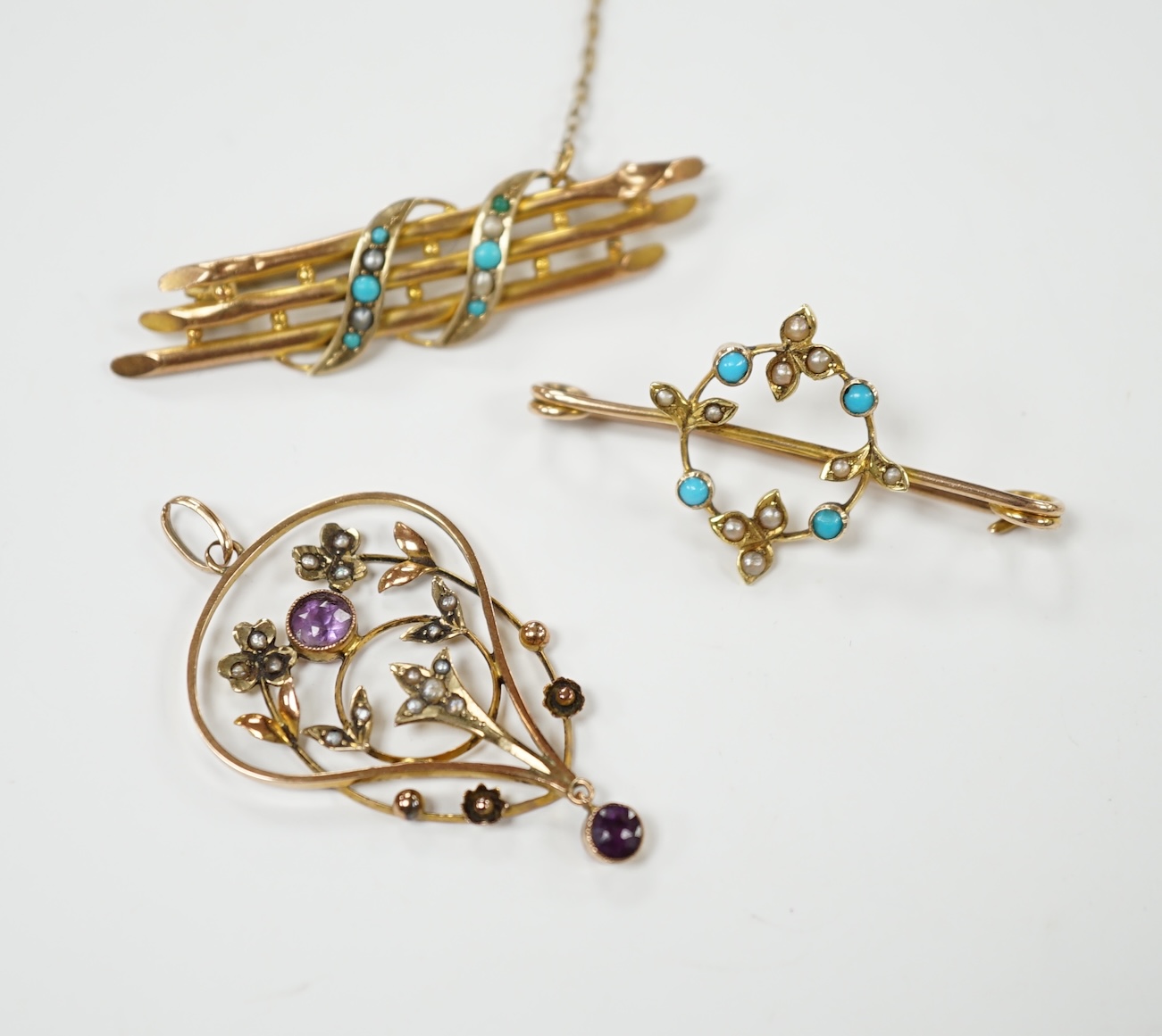An Edwardian 15ct, turquoise and seed pearl set brooch, 38mm, one other similar yellow metal brooch and a 9ct, amethyst and seed pearl set drop pendant, gross 6.8 grams. Condition - poor to fair                          
