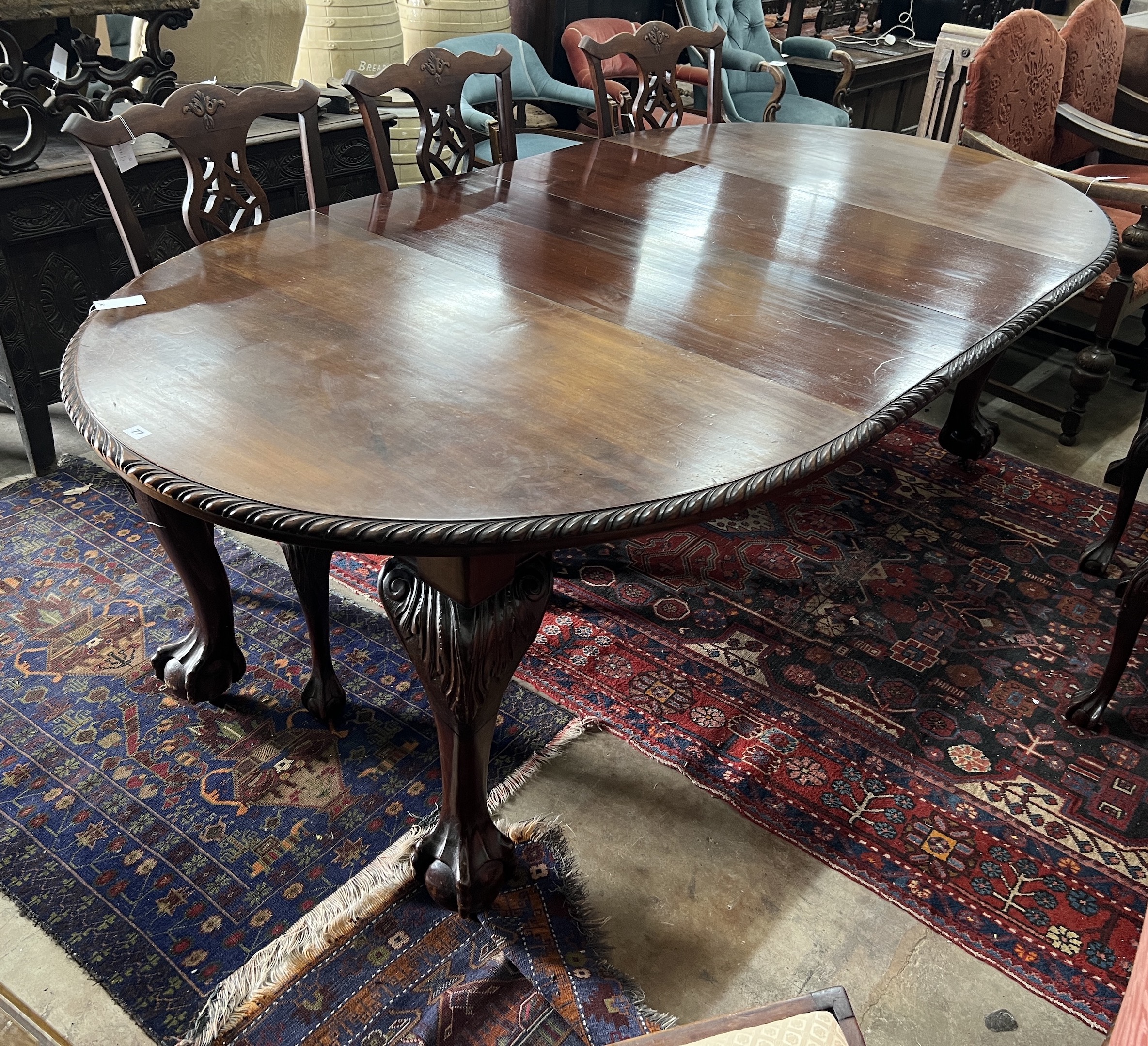 A 1920's Chippendale revival mahogany oval topped extending dining table, 238cm extended, two spare leaves, depth 120cm, height 76cm                                                                                        