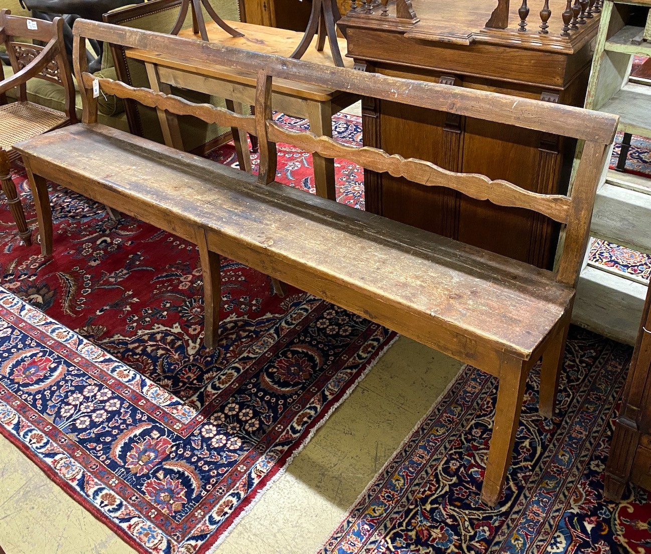 A 19th century French Provincial pine bench seat, length 214cm, depth 35cm, height 89cm                                                                                                                                     