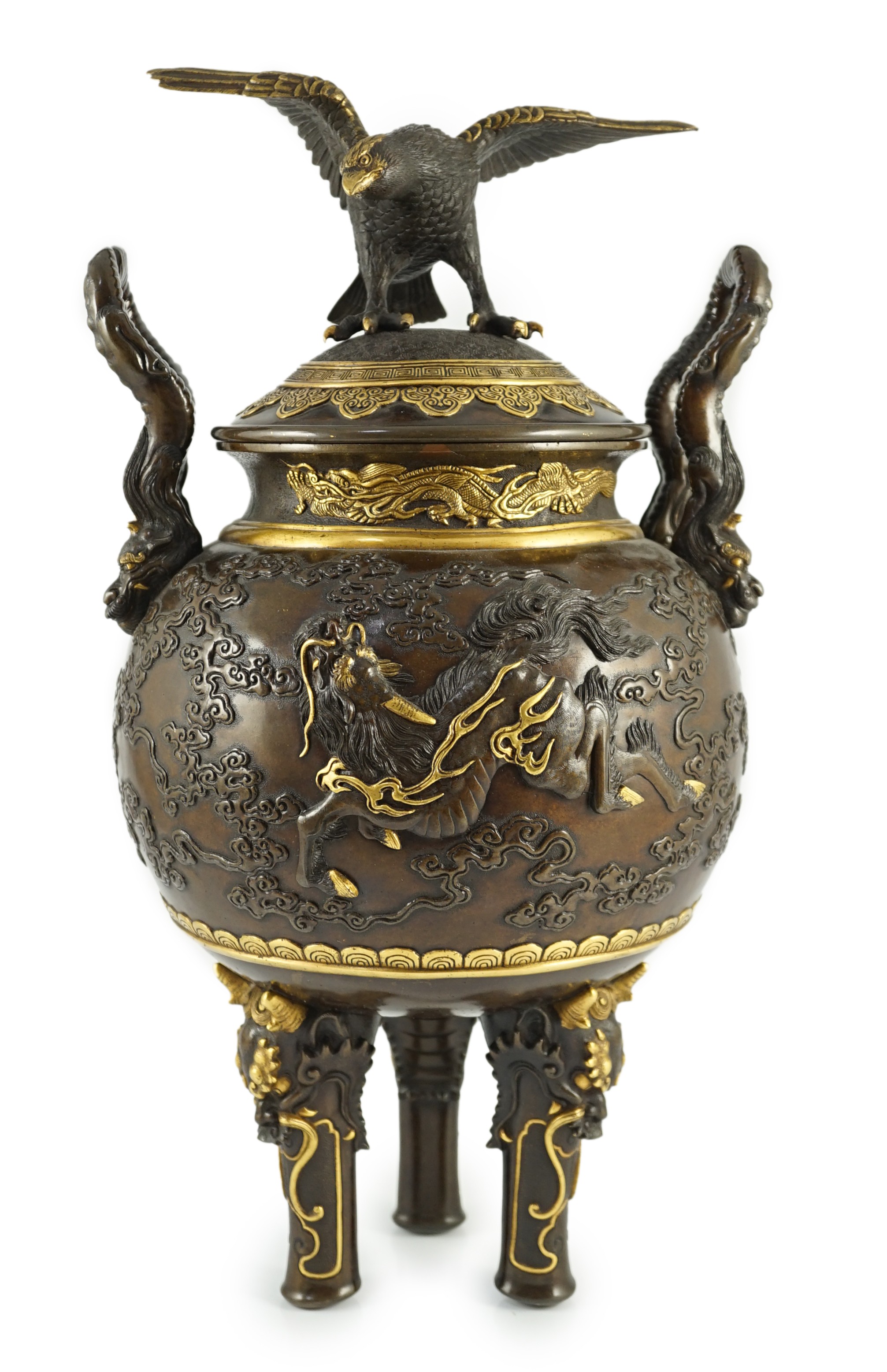 An impressive Japanese brown patinated and gilded bronze tripod koro and cover, by Miyao Eisuke, Meiji period, 42cm high, 23cm wide                                                                                         