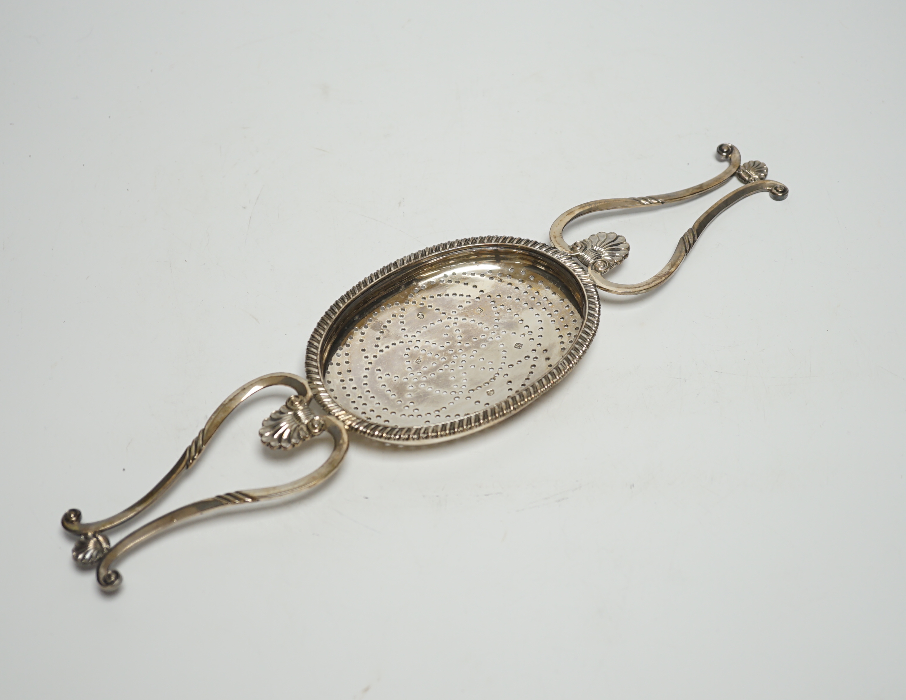 A George IV Scottish silver lemon strainer, Philip Grierson, Glasgow, 1821, 33.3cm, 167 grams                                                                                                                               
