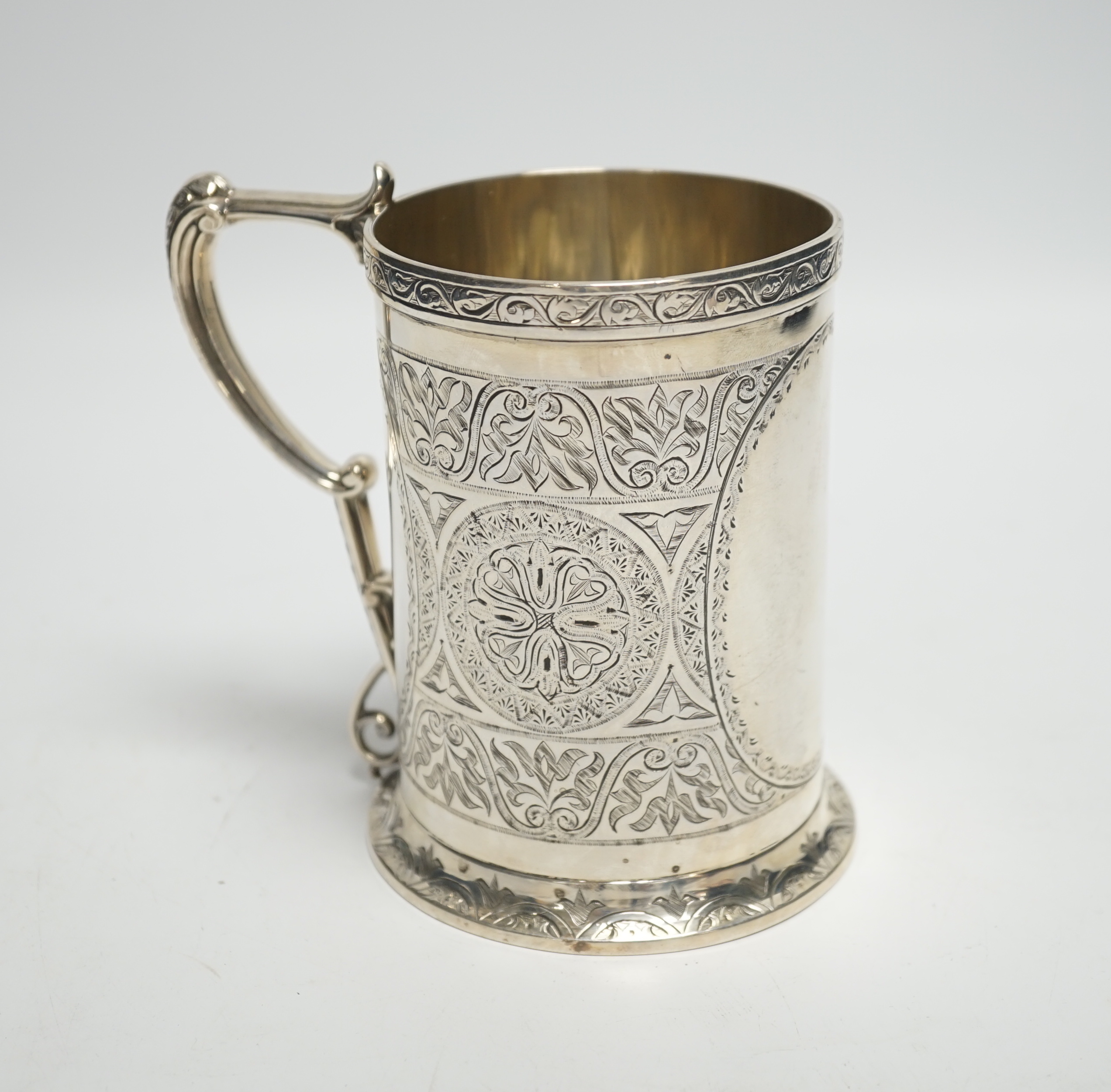 A Victorian engraved silver mug, with ornate handle, George Unite, Birmingham, 1869, height 12.4cm, 12.4oz.                                                                                                                 