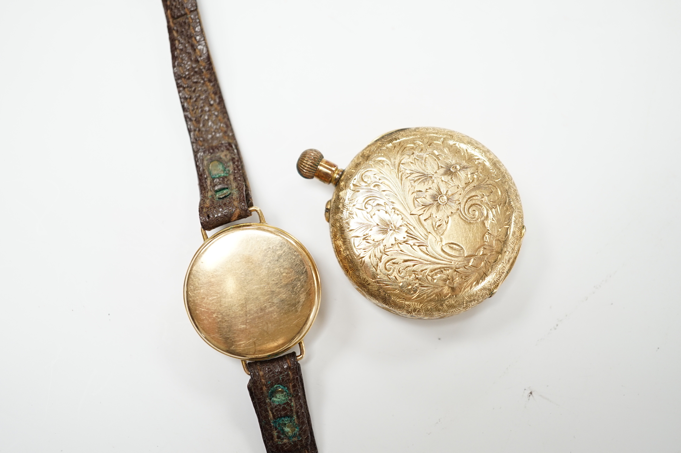 A 14k open faced keyless fob watch, with Roman dial, gross weight 31.7 grams and a lady's 9ct gold manual wind wrist watch (lacking winding crown), on a leather strap.                                                     