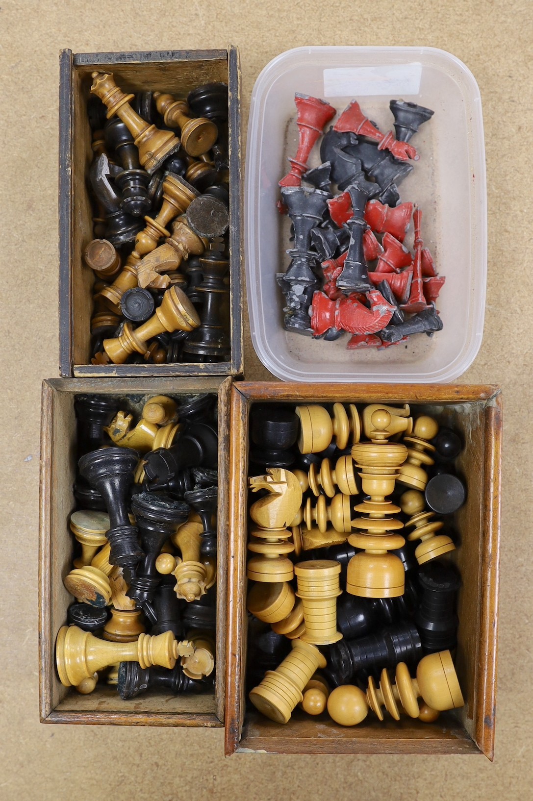 A painted lead chess set together with three boxed turned wooded chess sets.                                                                                                                                                