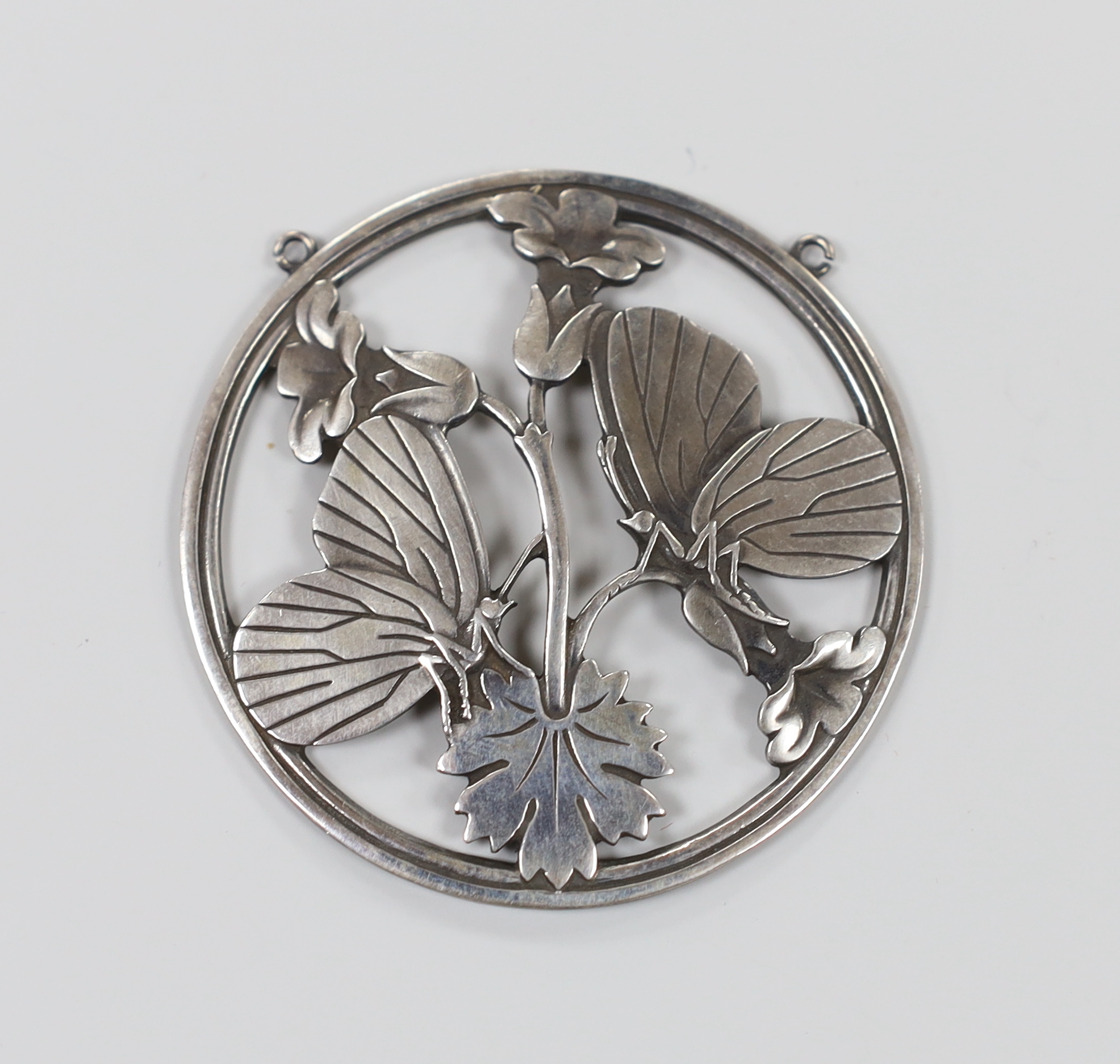 A Georg Jensen sterling pendant modelled with butterflies upon flowers, no.105, 5.25cm                                                                                                                                      