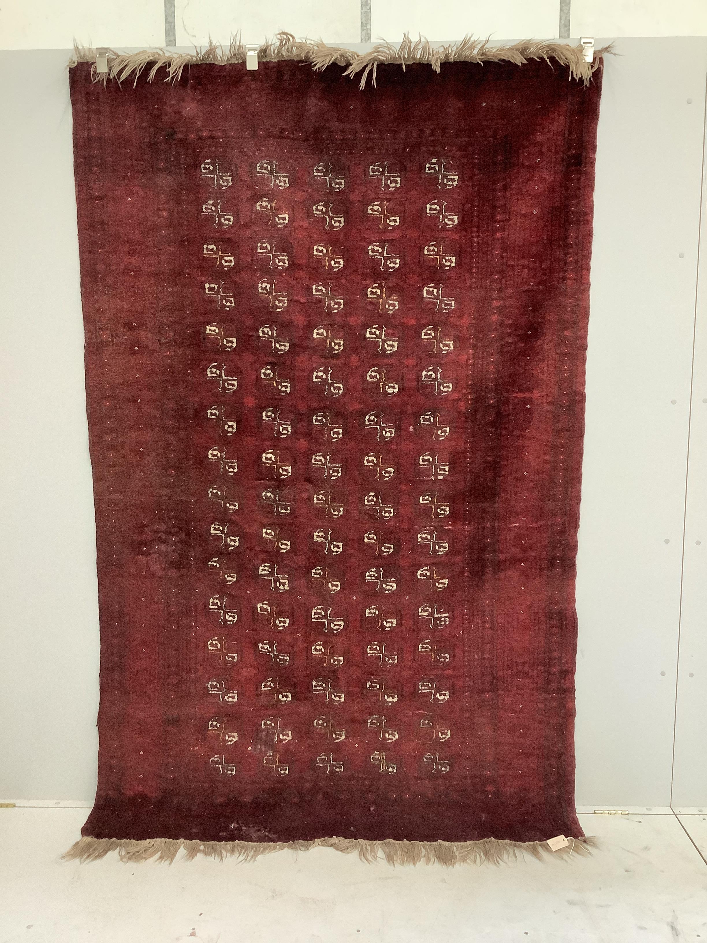 A Bokhara red ground carpet, 240 x 156cm                                                                                                                                                                                    