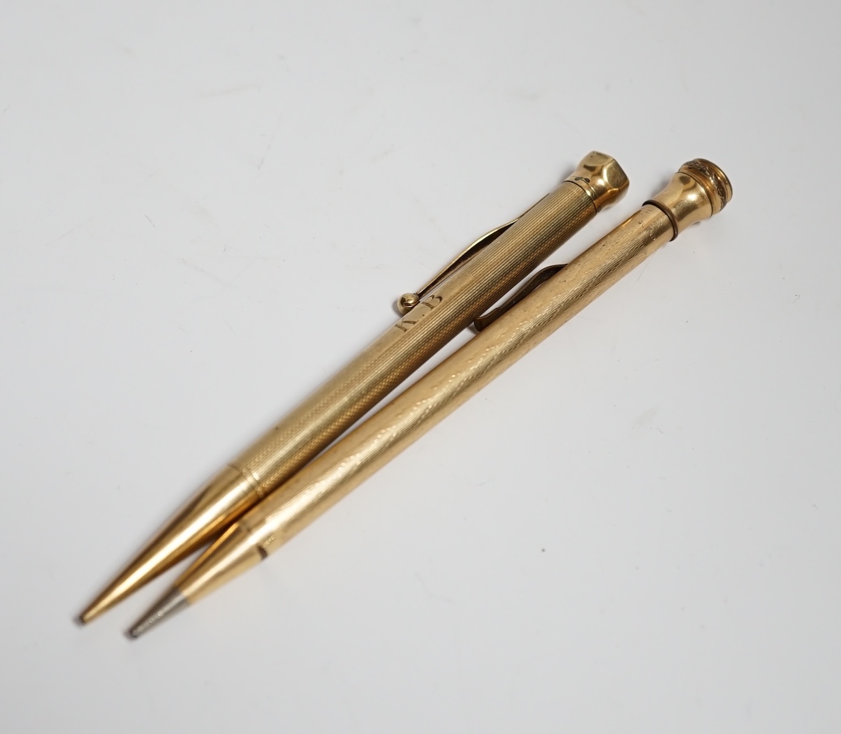 A 9 carat? (marks rubbed) pencil and another rolled gold pencil                                                                                                                                                             