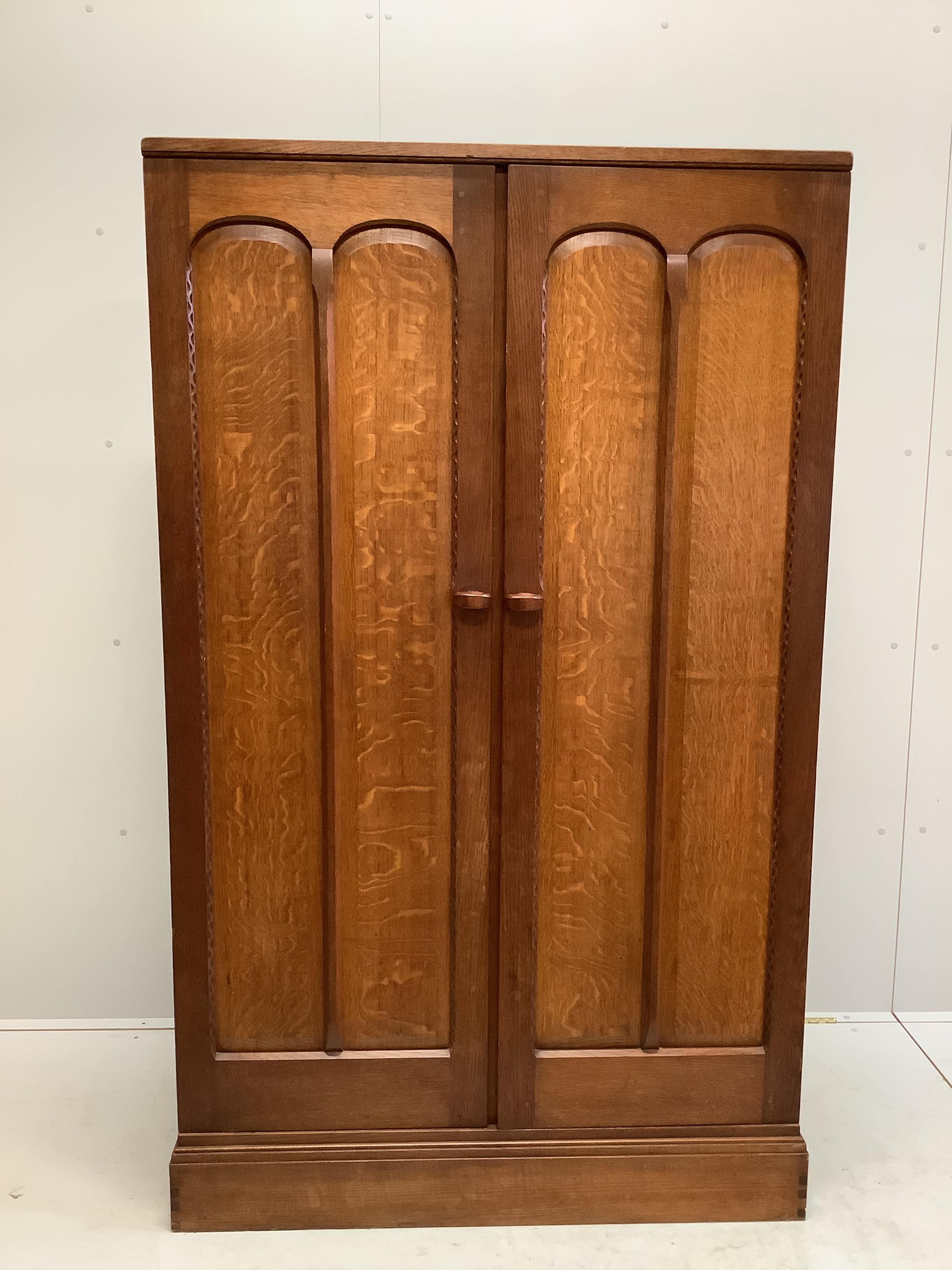 Stanley Webb Davies (1894-1978), an Arts & Crafts oak press cupboard, interior with makers cypher and dated 1951, width 107cm, depth 51cm, height 177cm                                                                     