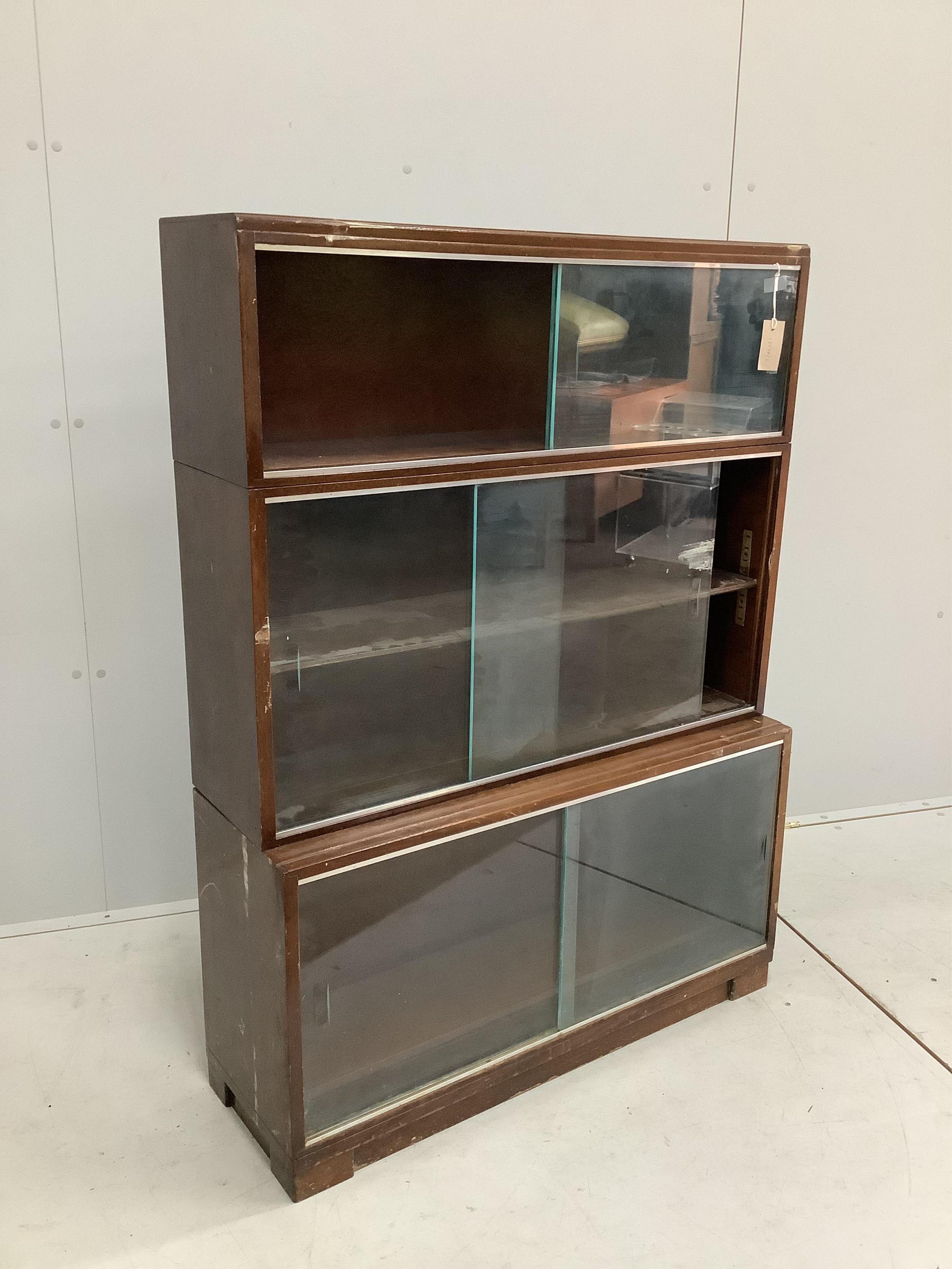 A mid century three section Minty bookcase, width 90cm, height 131cm. Condition - poor                                                                                                                                      