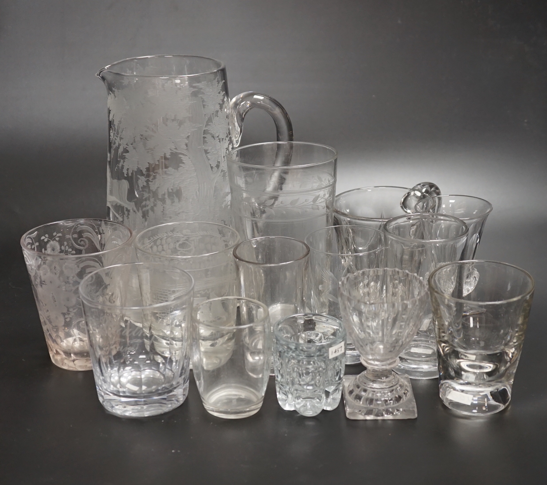 Fourteen 19th century glass items, including a jug heavily engraved with a scene of a stag in a woodland glade, an engraved Sunderland Bridge tumbler, together with another three engraved tumblers, plus some smaller brea