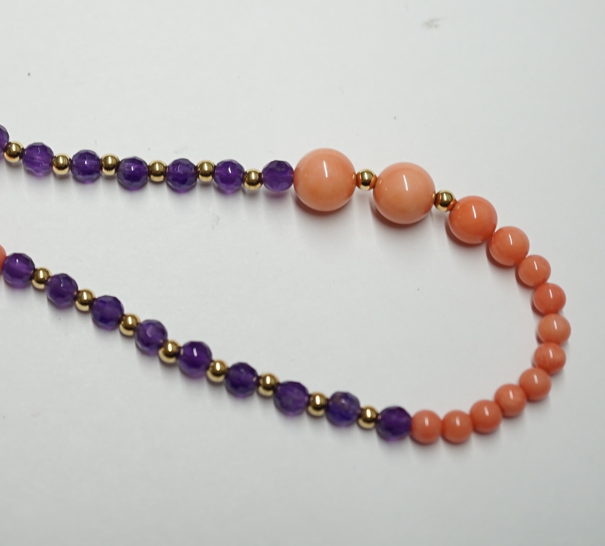 A 9ct amethyst and coral long necklace, 124cm. Condition - fair                                                                                                                                                             