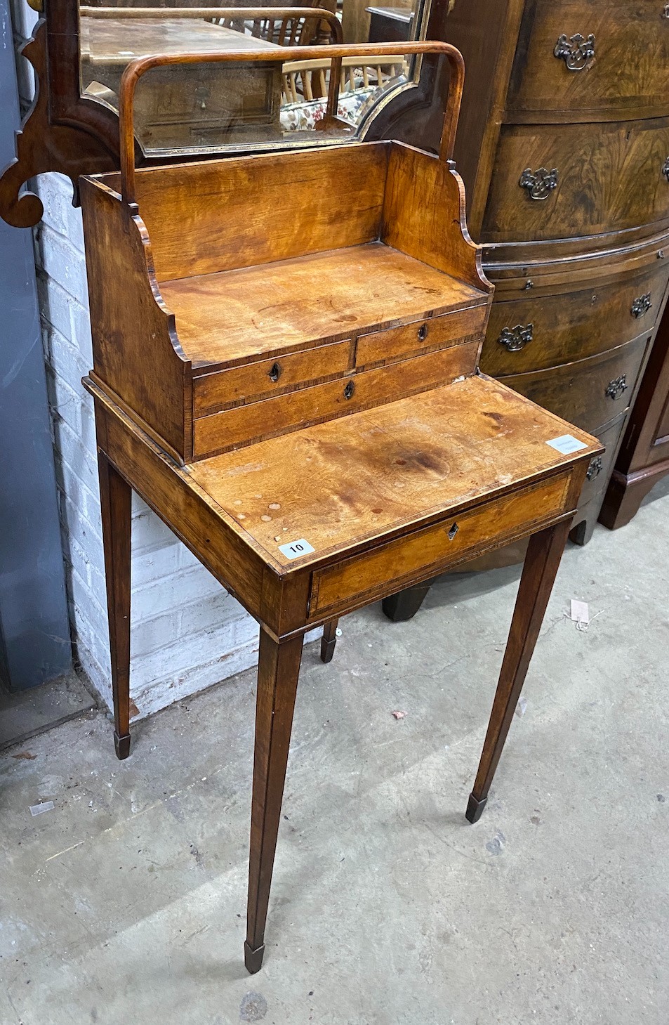 A George III satinwood cheveret or reading table with removeable book carrier, width 48cm, depth 45cm, height 112cm                                                                                                         