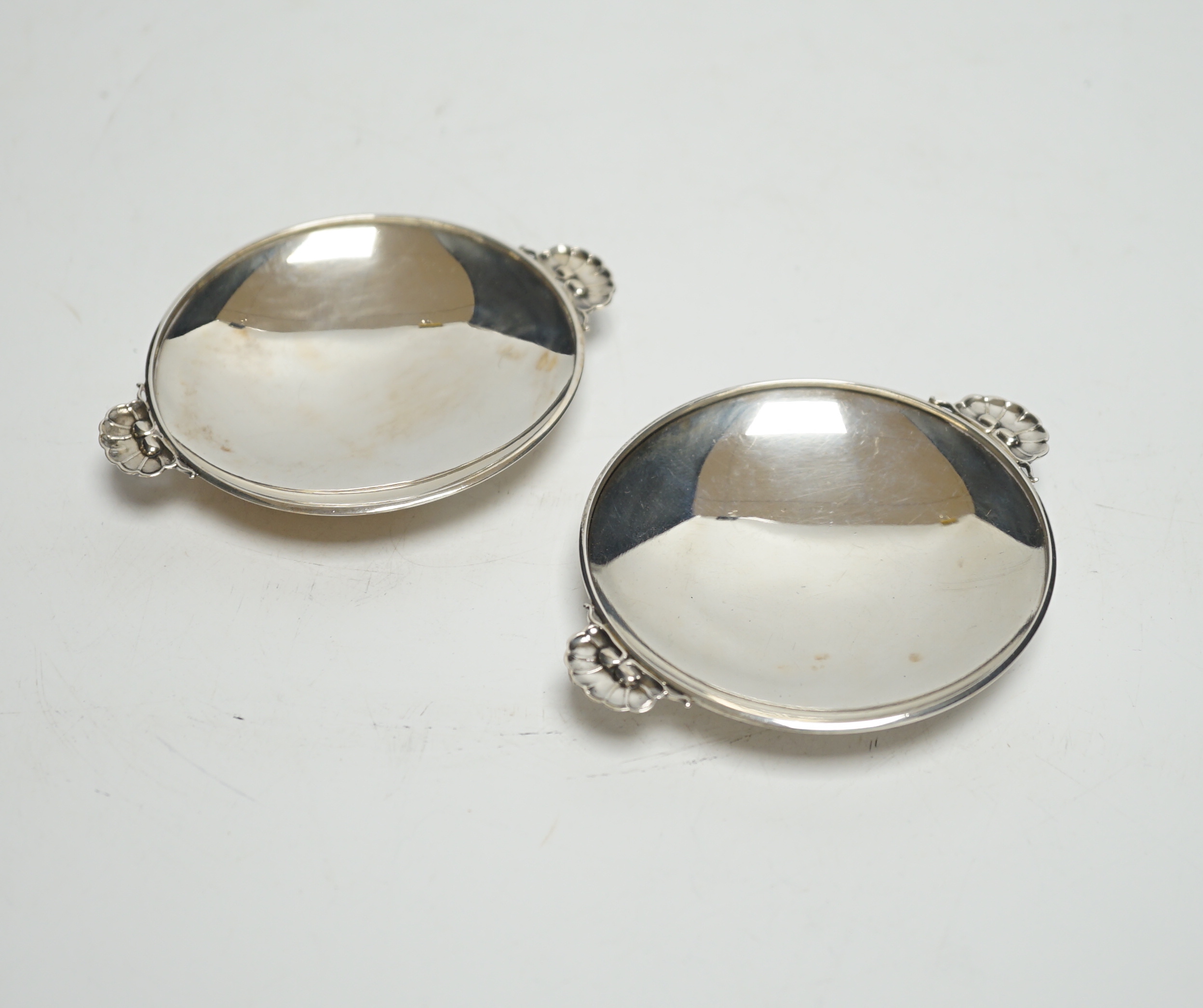 A pair of small 1930's Georg Jensen sterling dishes, with fluted lug handles, 94mm.                                                                                                                                         