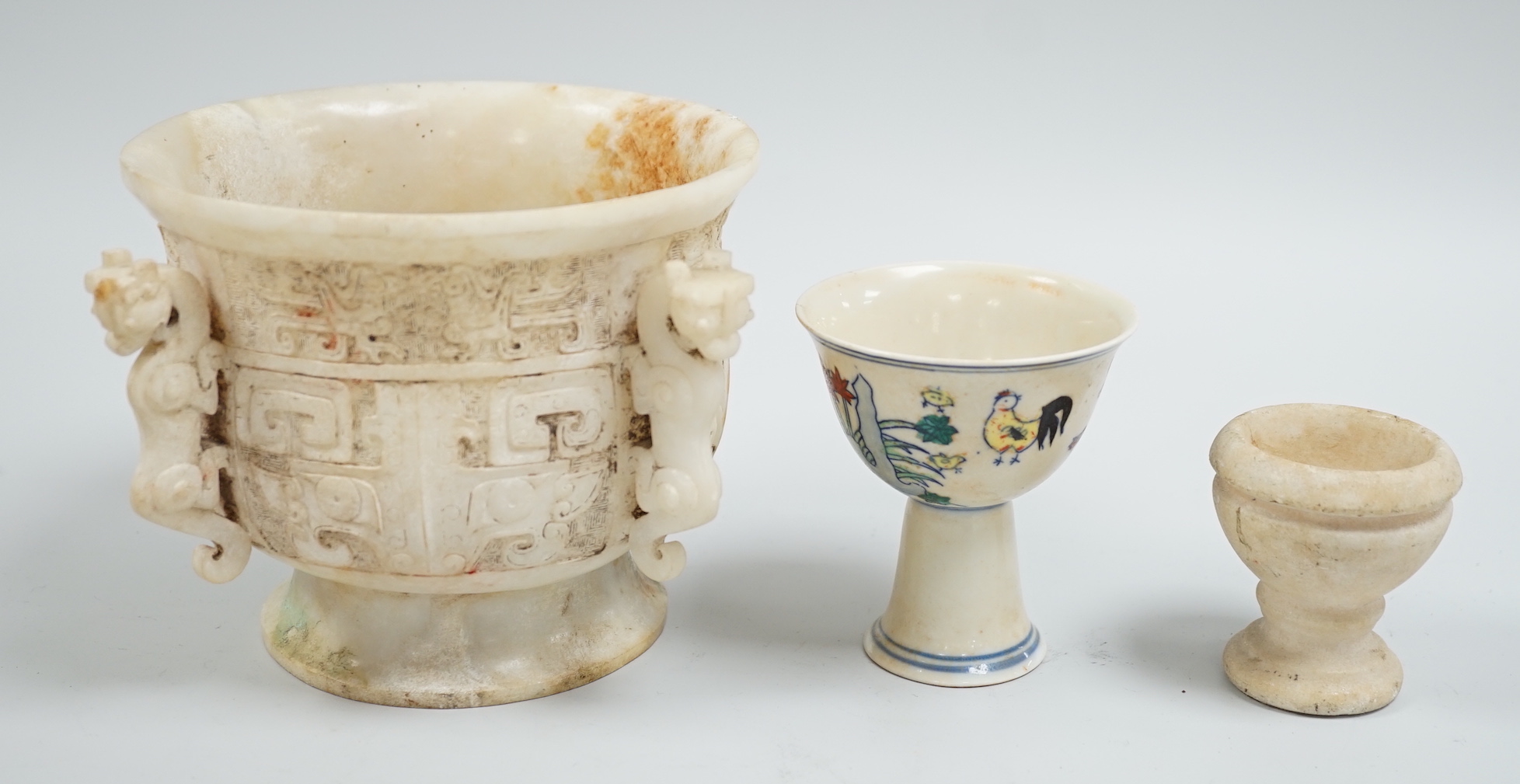 A Chinese burnt jade or hardstone censer, a stone cup and a doucai stem cup, censor 12cm high                                                                                                                               