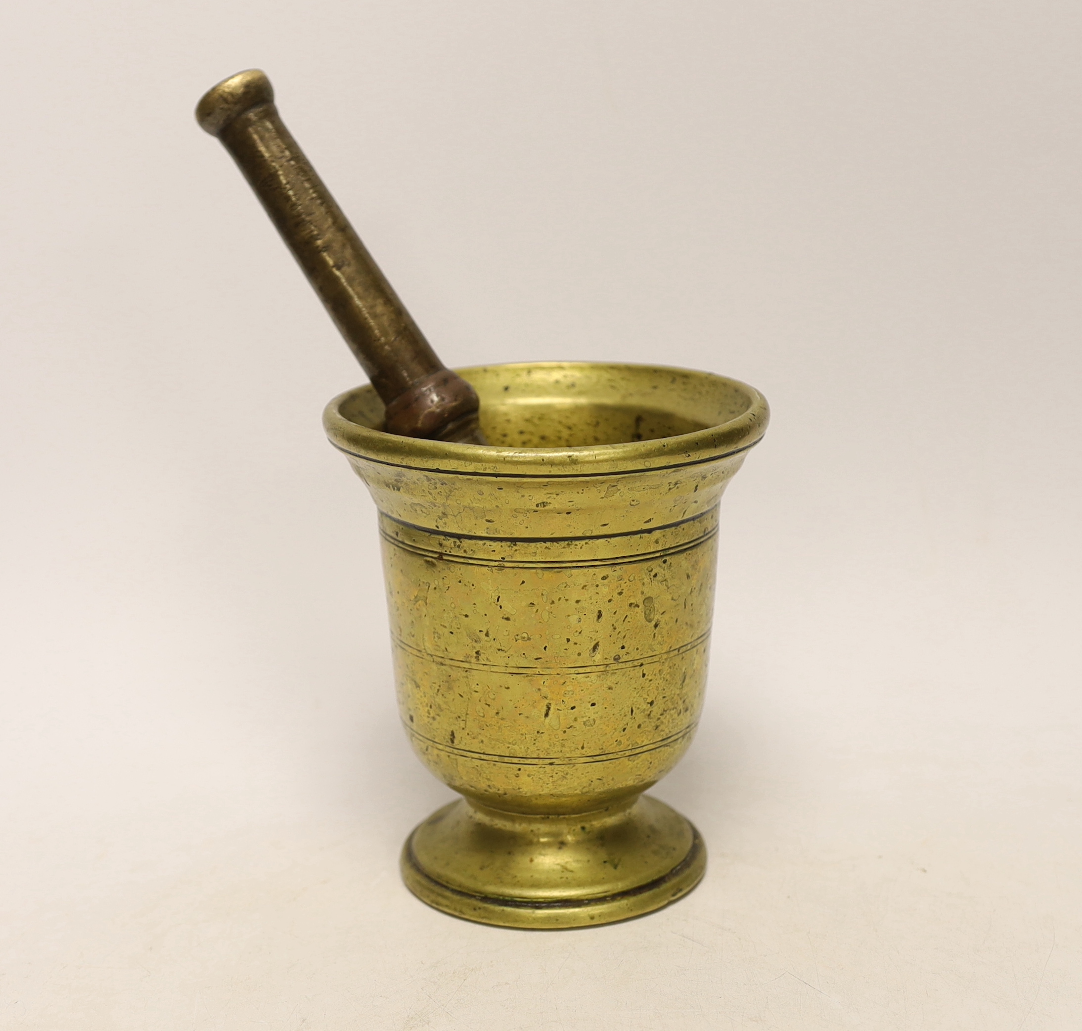 An antique bronze pestle and mortar, 15cm high                                                                                                                                                                              