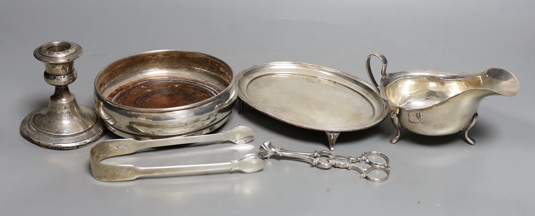 Assorted small silver, including a George V oval teapot stand, a modern mounted wine coaster, pair of sugar nips, etc.                                                                                                      