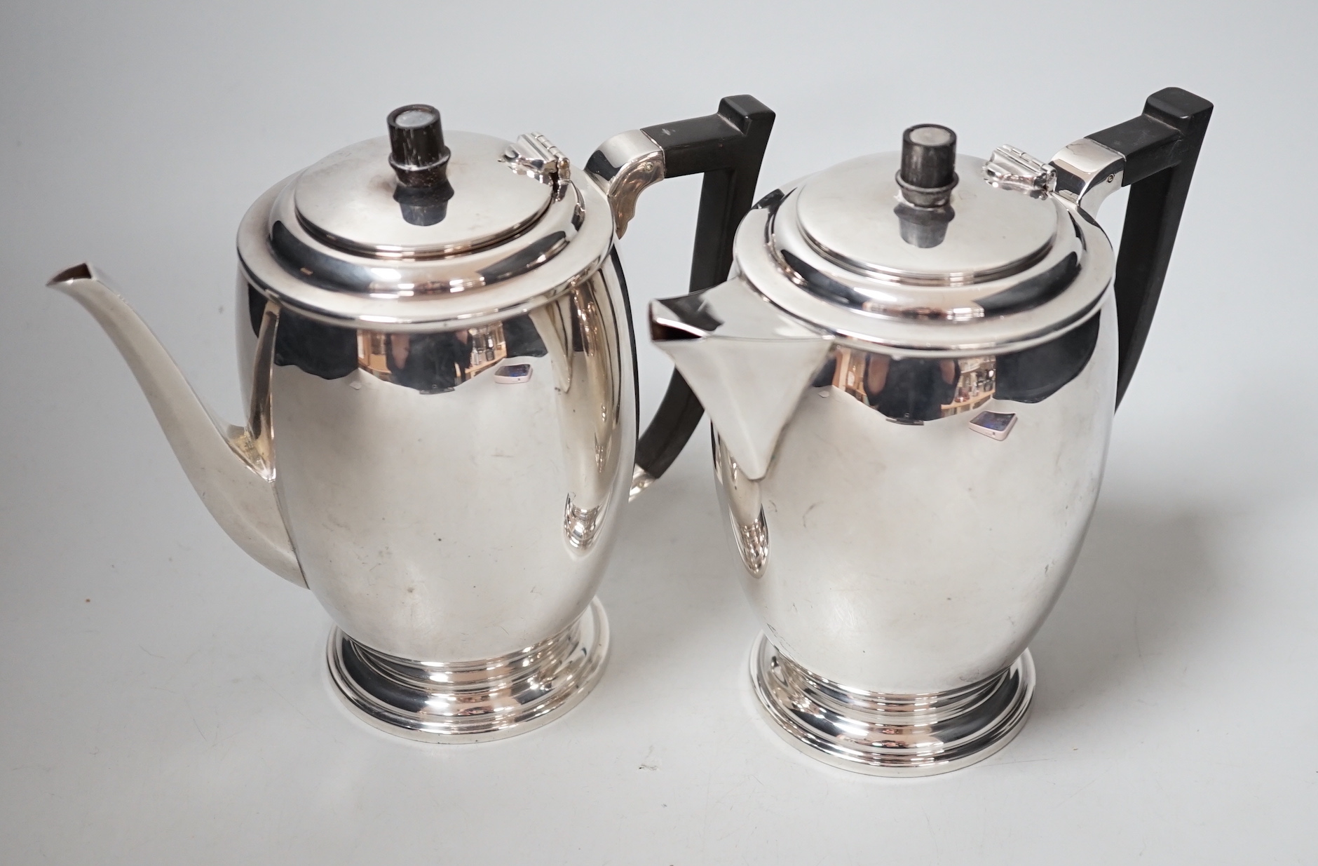 A George V silver cafe au lait pair by Hukin & Heath, Birmingham, 1934, height 15.8cm, gross weight 27.6oz.                                                                                                                 