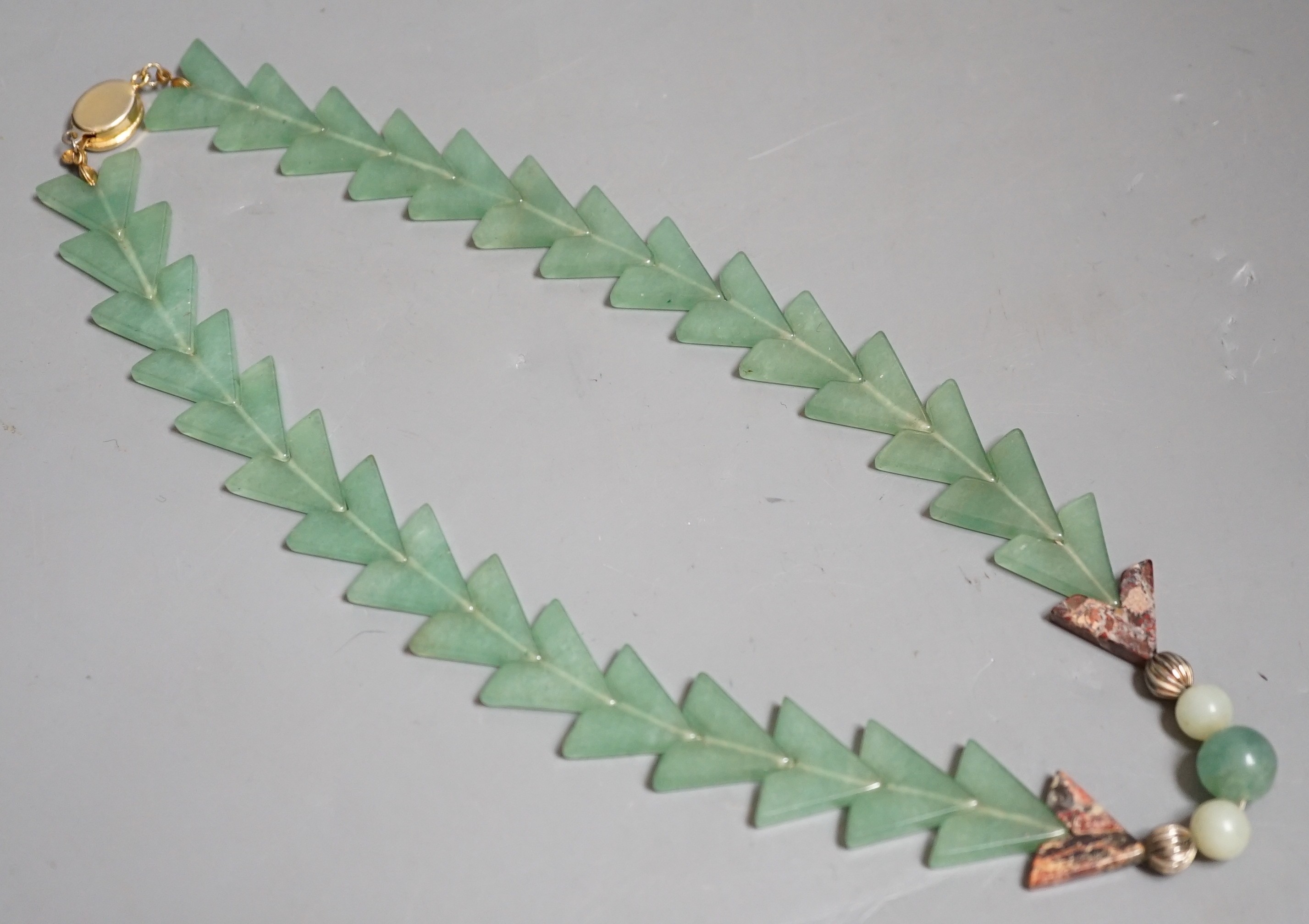 A Chinese jade arrowed pendant necklace                                                                                                                                                                                     