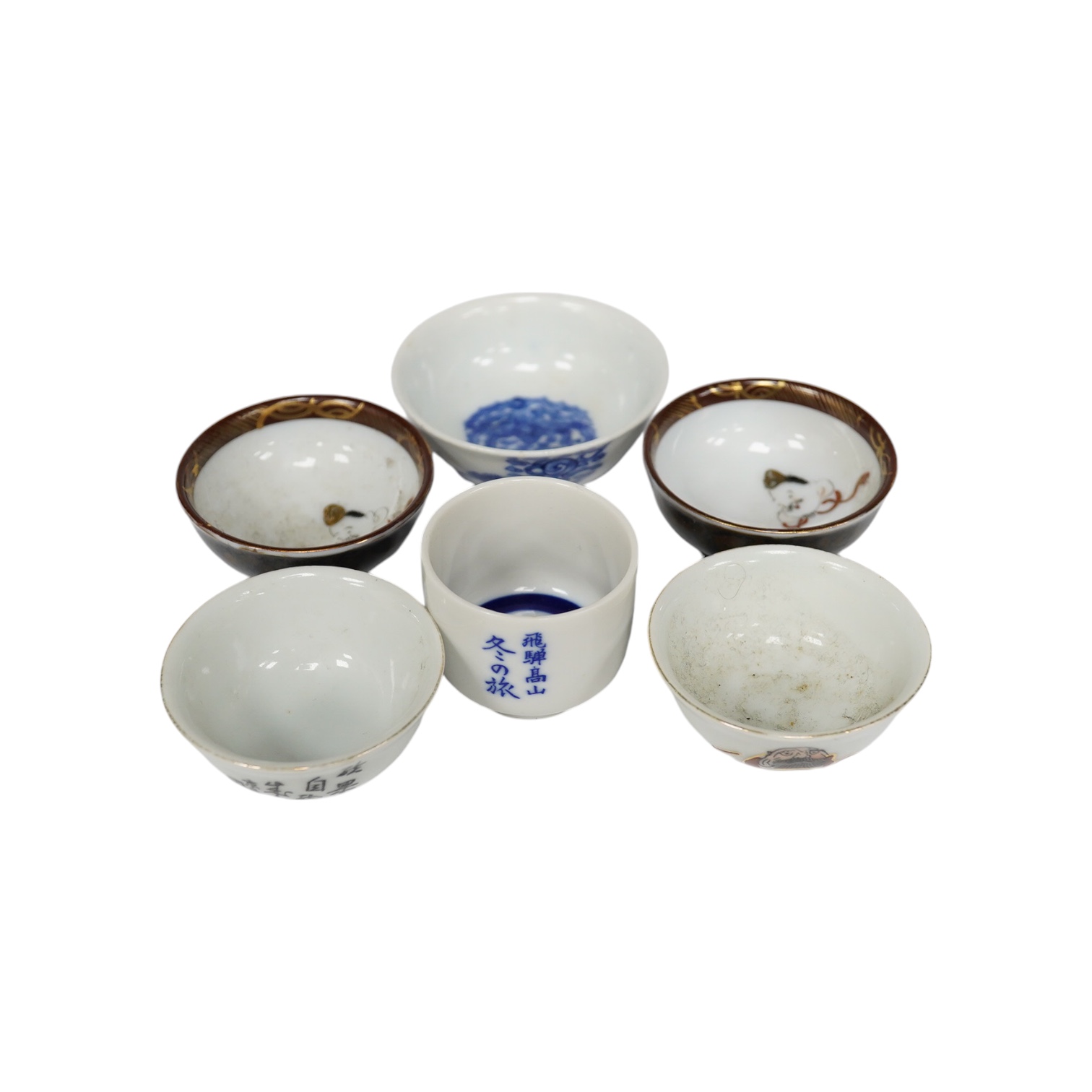 Six Japanese sake bowls, two pairs and two single, tallest 4cm. Condition - some chips                                                                                                                                      
