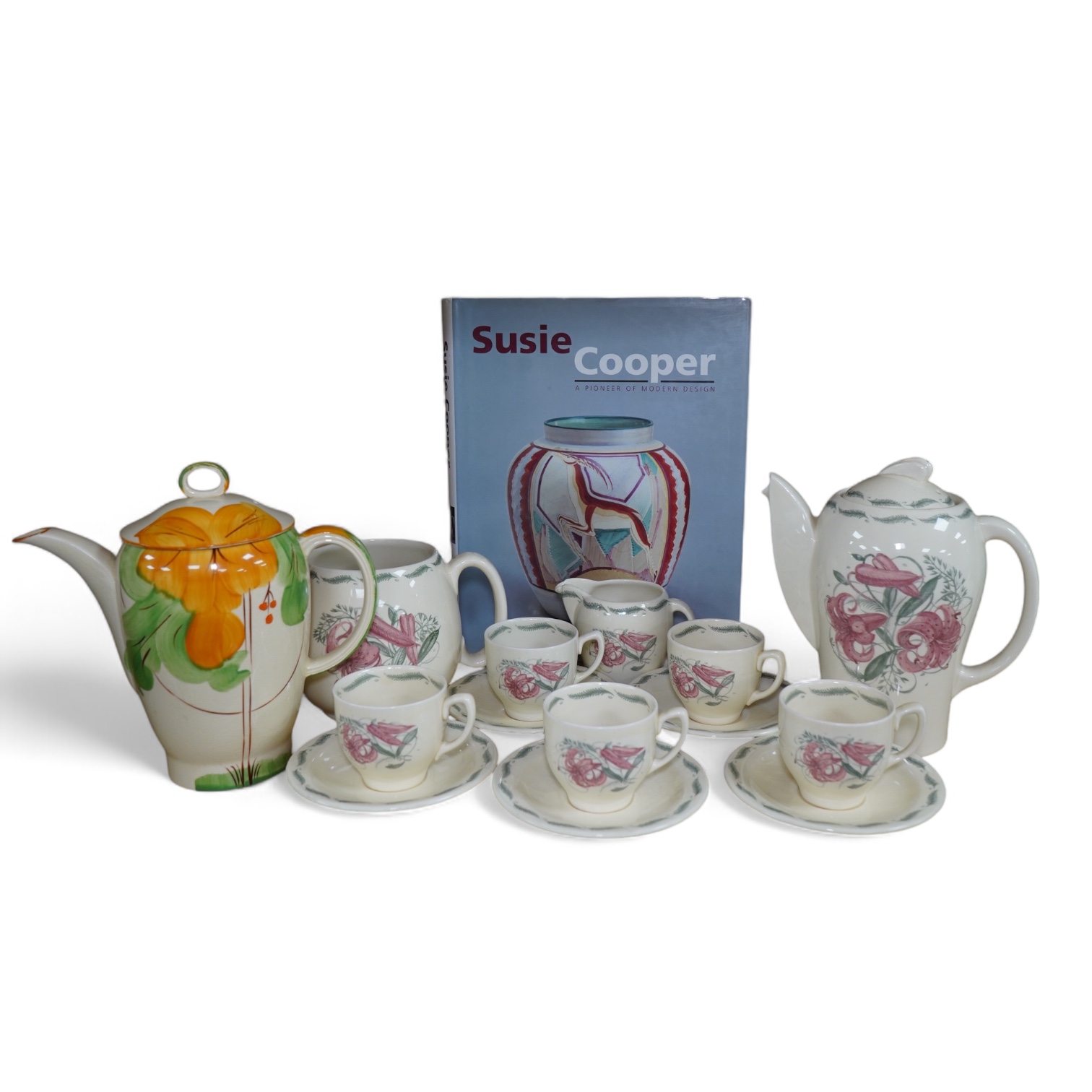 A Susie Cooper style 'Tiger Lily' pattern teaset, possibly by Wood & Co., a Susie Cooper reference book and a later painted Falcon shape coffee pot. Condition - good                                                       