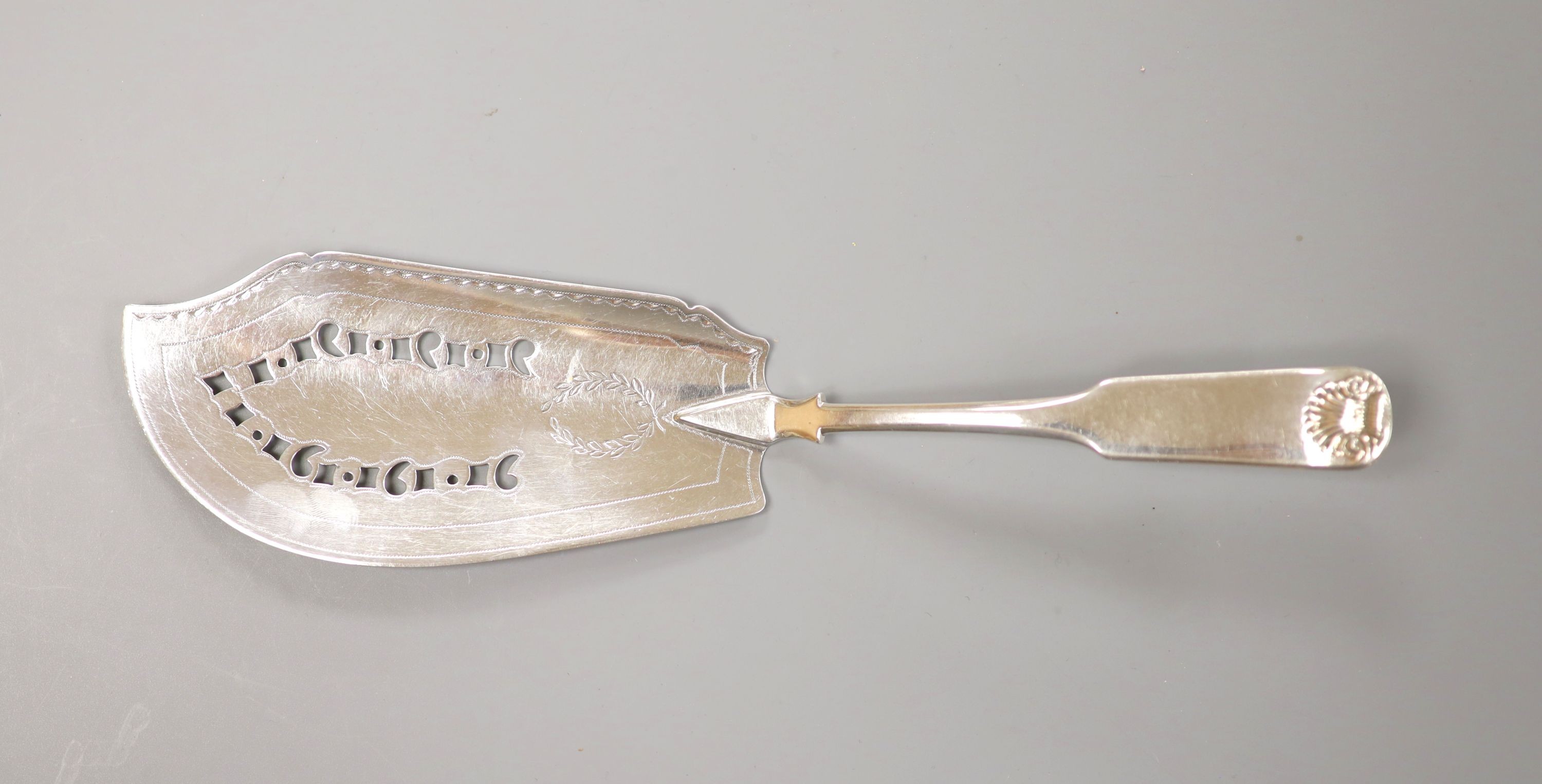 A George III Scottish silver fiddle and shell pattern fish slice, John Graham, Edinburgh, c. 1806 (marks rubbed), 30cm, 139 grams.                                                                                          