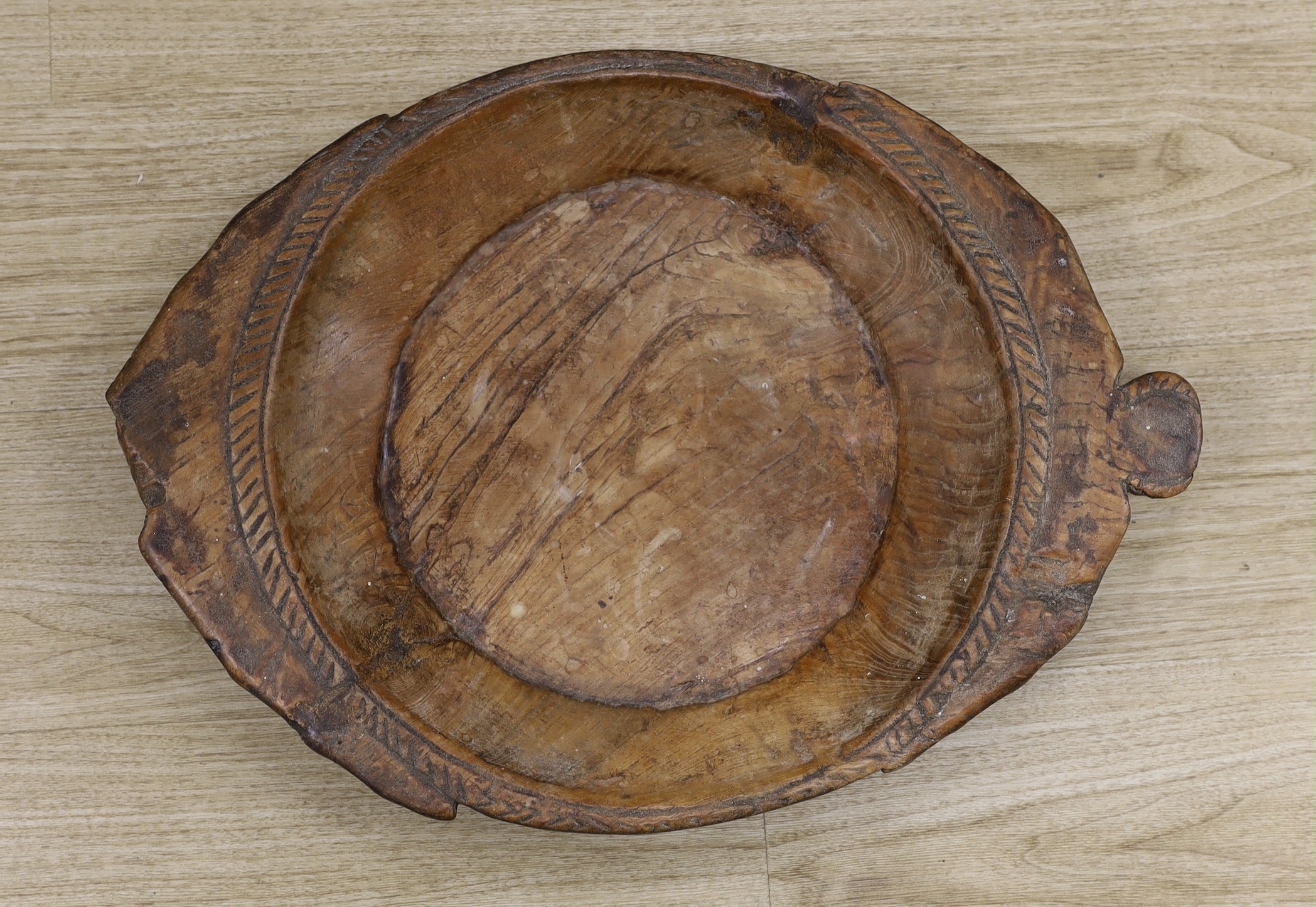 An 18th century/19th century provincial elm serving dish, 58 cms wide                                                                                                                                                       