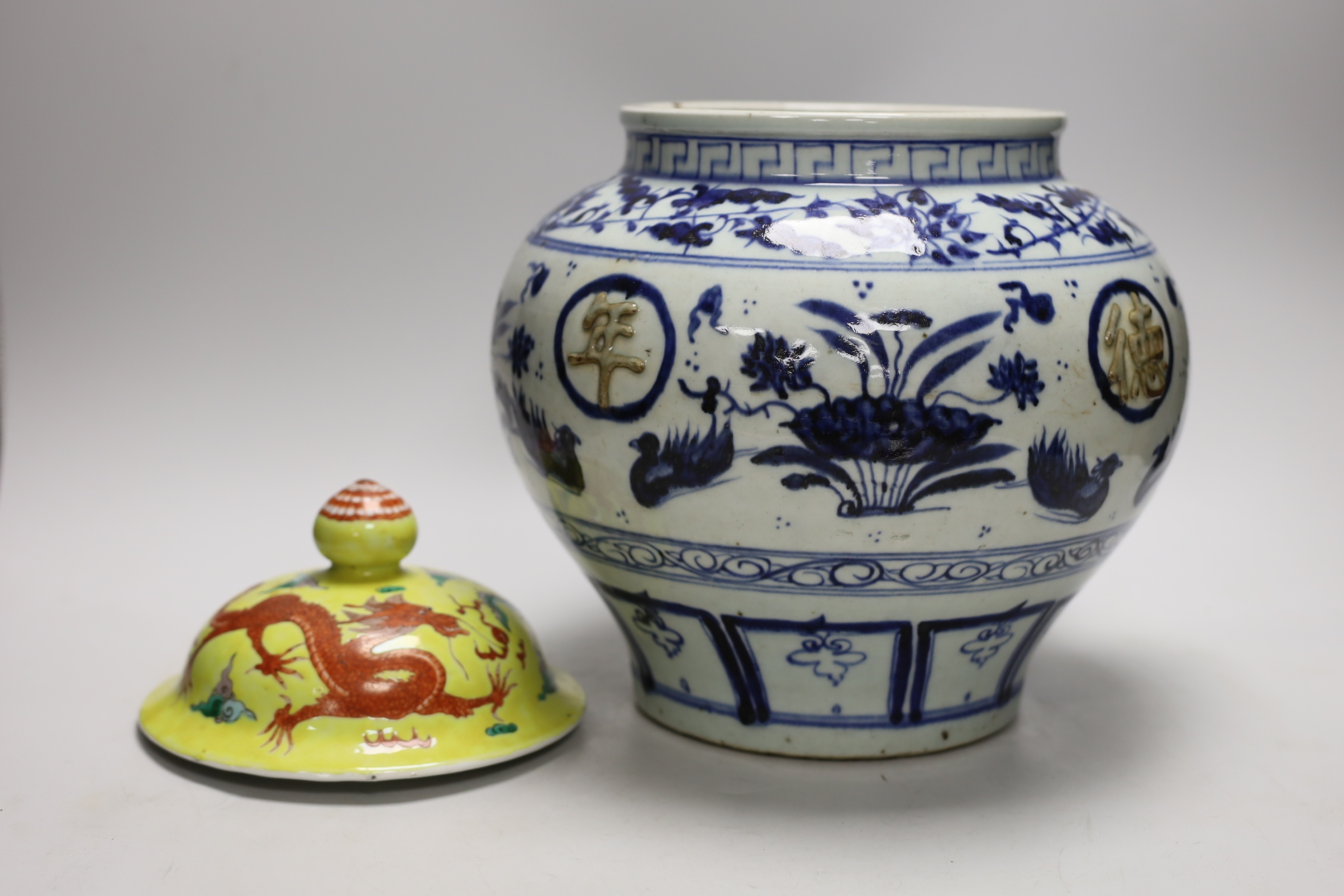 A Chinese blue and white jar and a 19th century Chinese enamelled porcelain 'dragon' cover, vase 24cm high                                                                                                                  