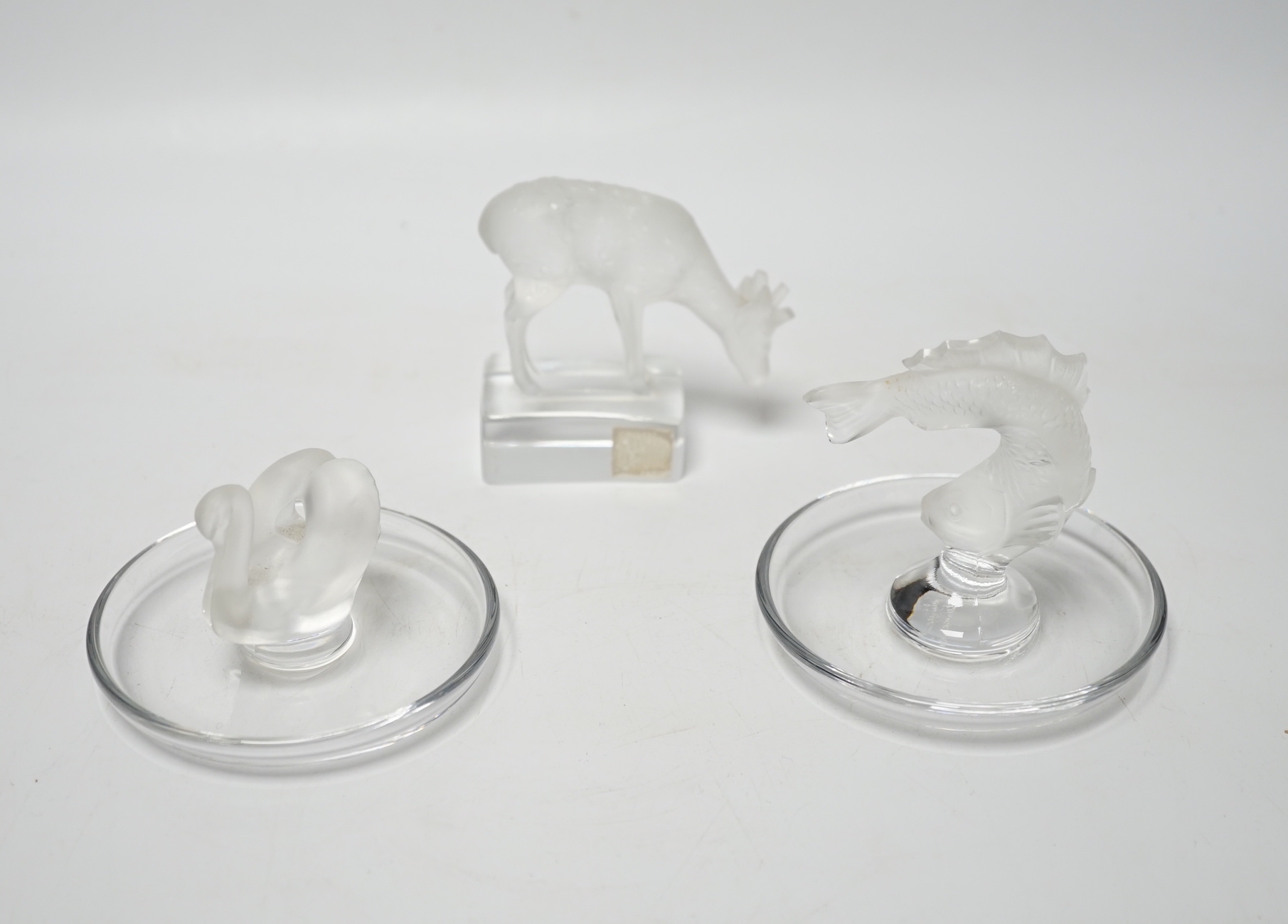 Rene Lalique - two glass pin dishes modelled as a swan and a fish together with a paperweight modelled as a giraffe, signed ‘Lalique France’ to base, tallest 9.5cm high (3)                                                