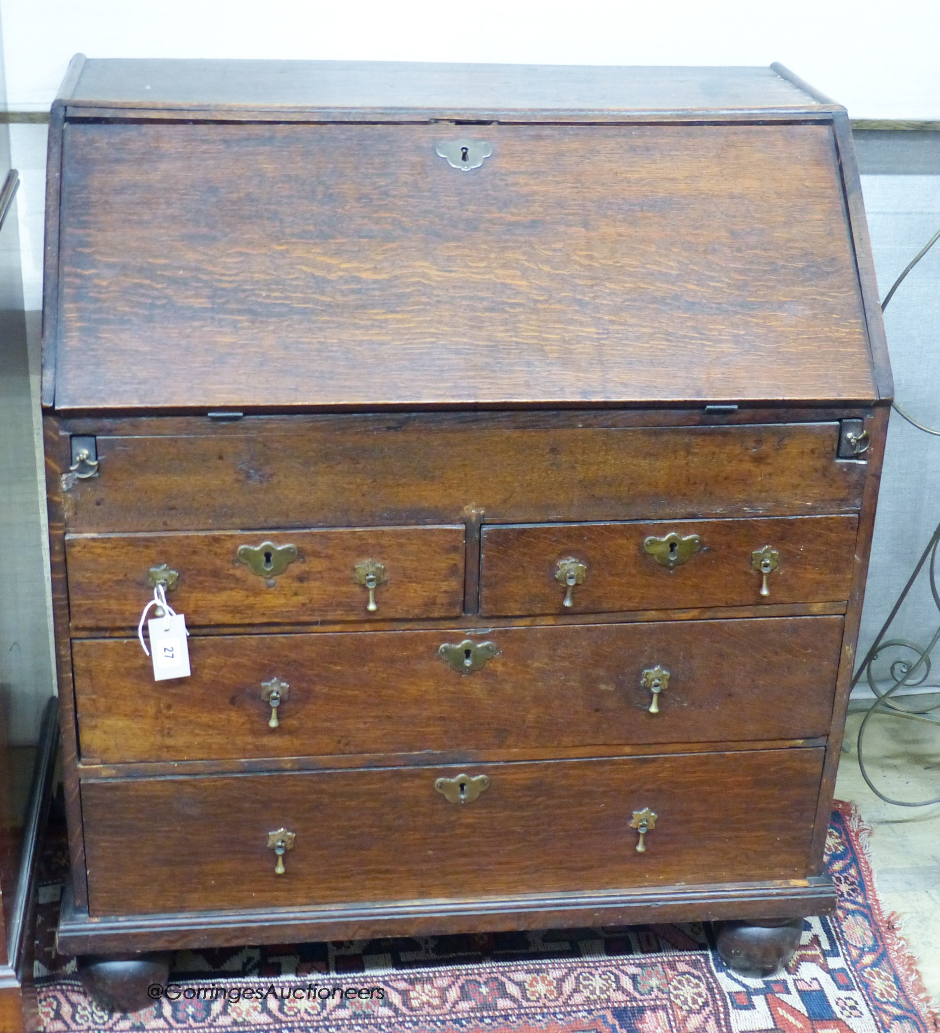 A mid-18th century oak bureau, width 84cm, depth 51cm, height 98cm                                                                                                                                                          