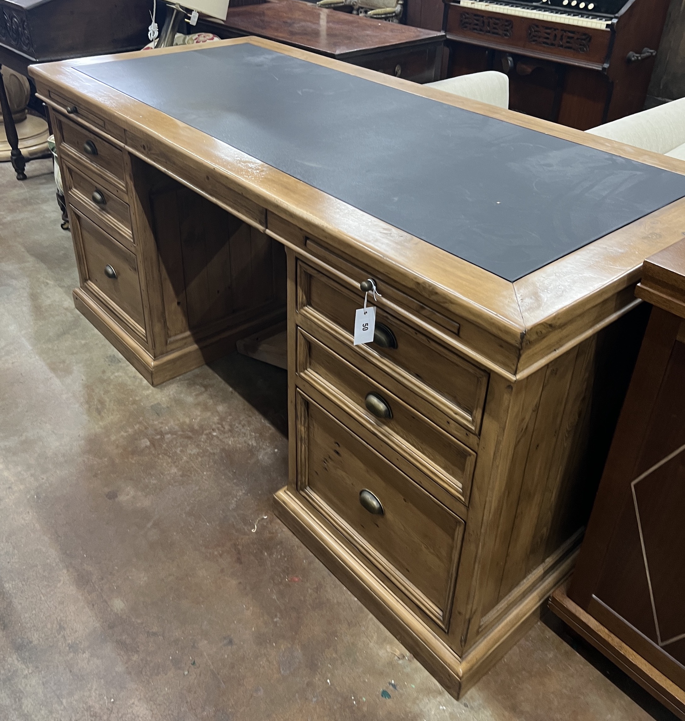 A contemporary reclaimed wood kneehole desk, width 174cm, depth 79cm, height 82cm                                                                                                                                           