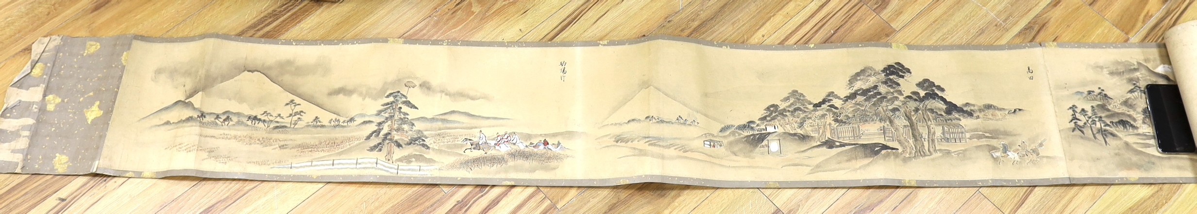 A Japanese landscape painting on paper hand scroll, Edo period, titled views, now in two parts, incomplete, image 27cm high x approximately 470cm wide                                                                      