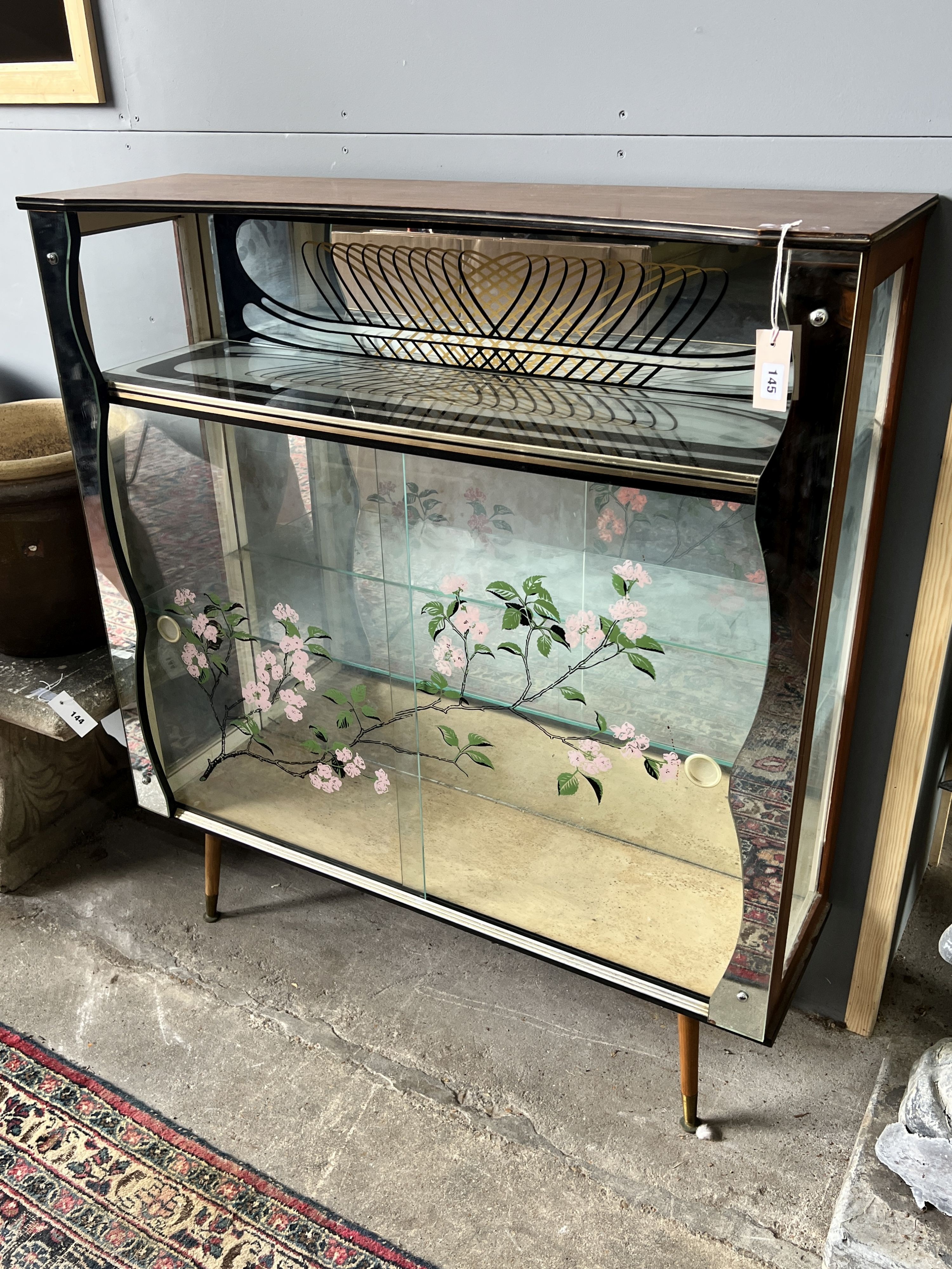 A 1950’s mirrored display cabinet, width 103cm, depth 30cm, height 114cm                                                                                                                                                    