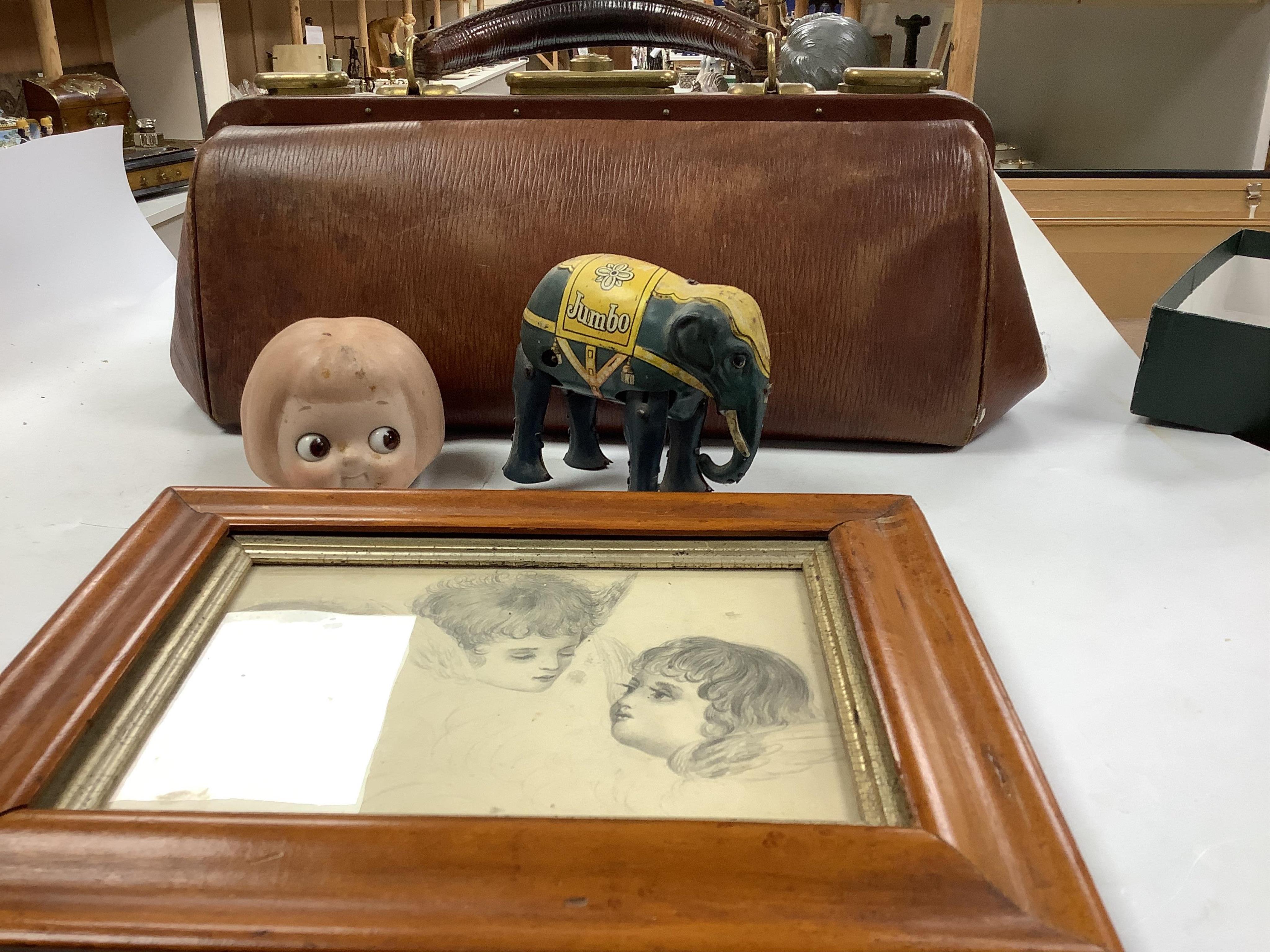 A pair of brass letter scales, a novelty ink pot, a Gladstone bag, a maple framed sketch, a googlie eyed doll’s head, a tin plate Jumbo toy, Dominoes, boxed seal kit and a leather travelling stationary case etc., scales 