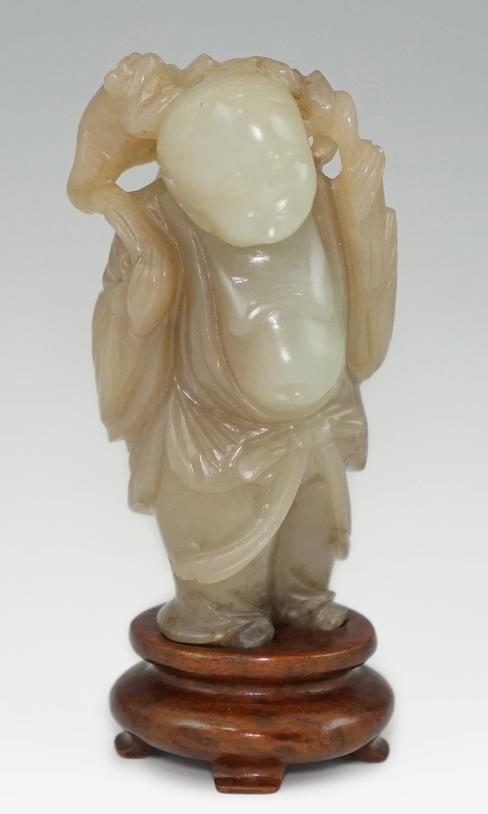 A Chinese pale celadon and brown jade group of Liu Hai and his three legged toad, Qianlong period (1736-95)                                                                                                                 