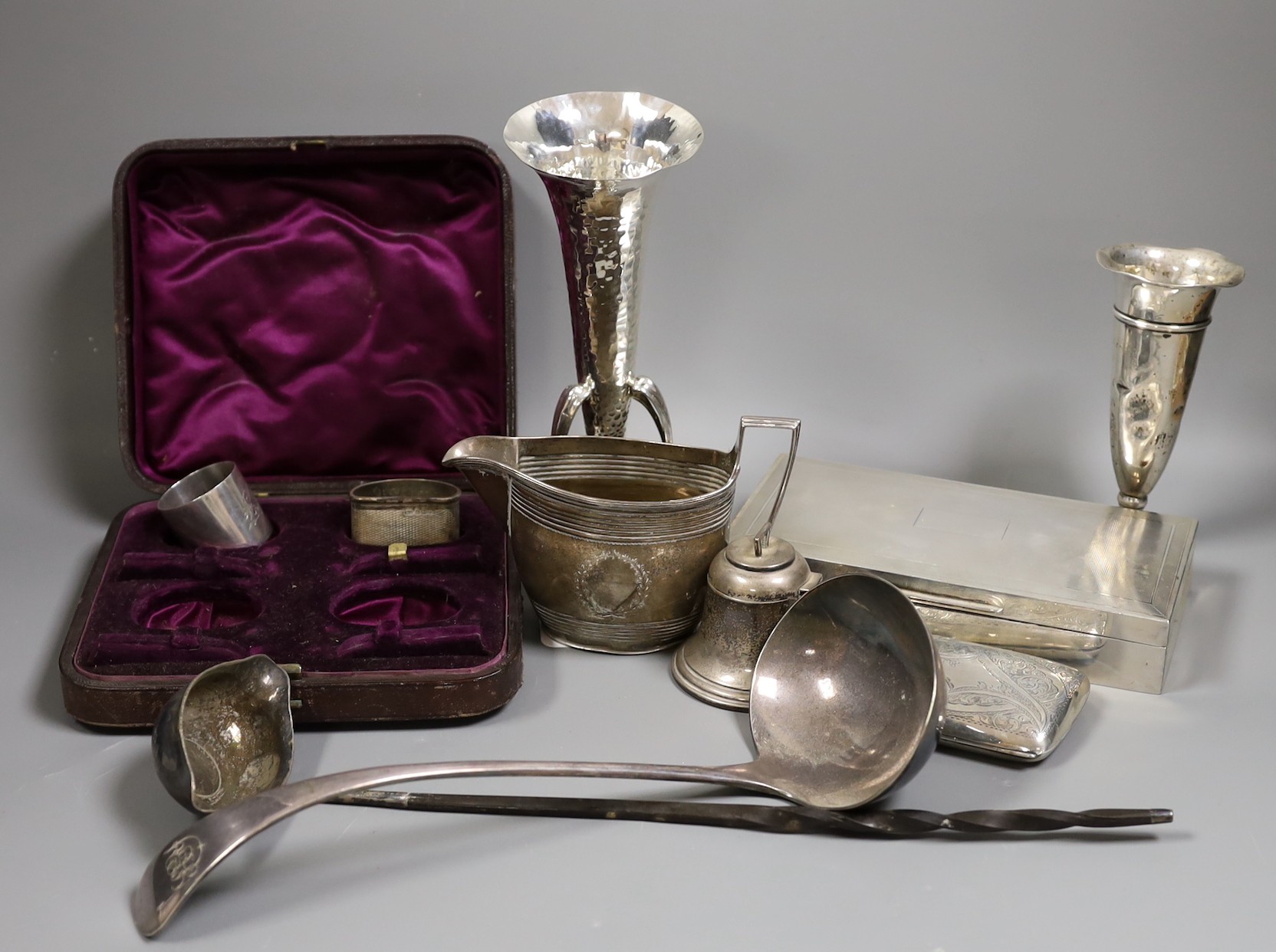 A mixed collection of small silver items to include a cigarette box, a posy vase, condiments, napkin rings, cigarette cases, a planished Scottish posy vase, by John A. Fettes, Glasgow, 1904, 20.4cm, toddy ladle, hip flas