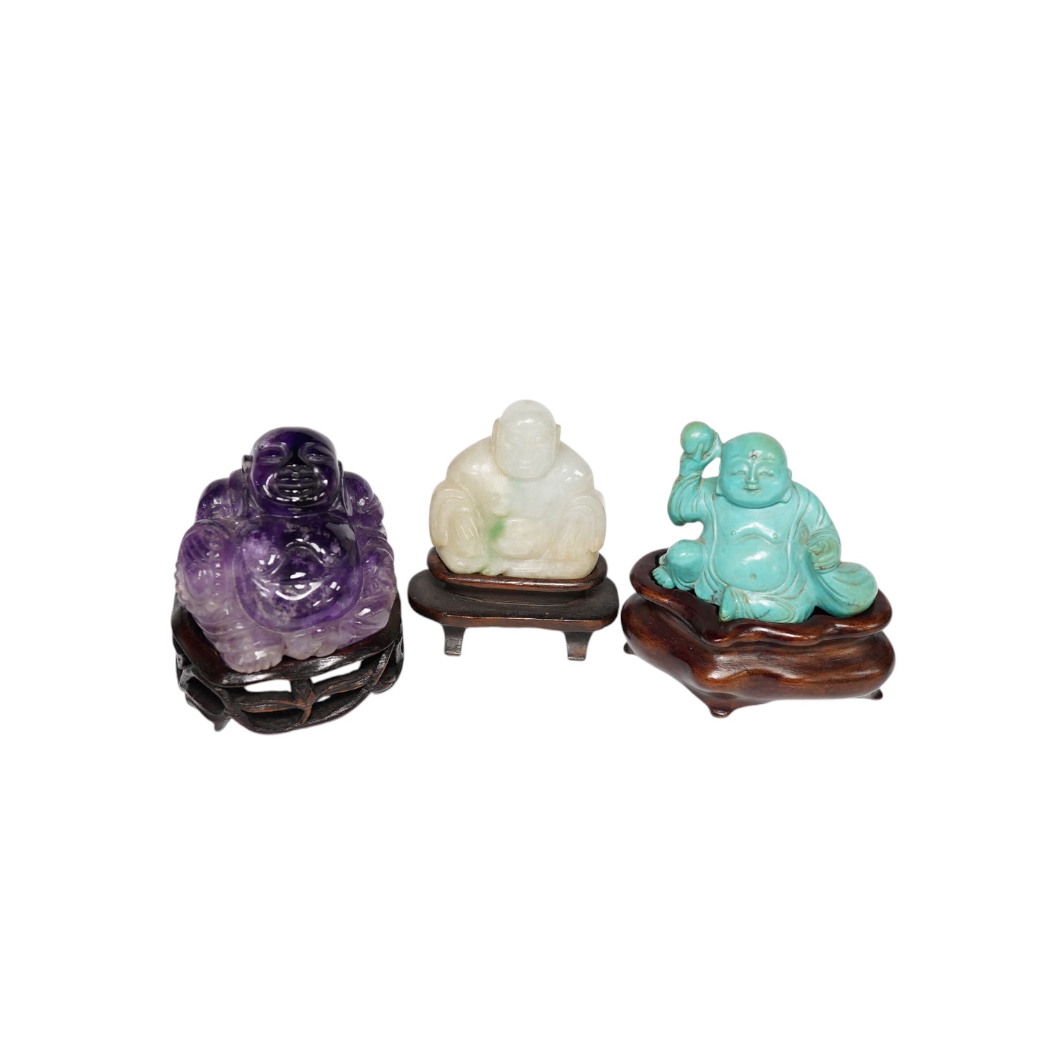 Three Chinese hardstone carvings of Budai, in jadeite, turquoise matrix and amethyst crystal, largest amethyst 4.5cm wide at base (3). Condition - good                                                                     