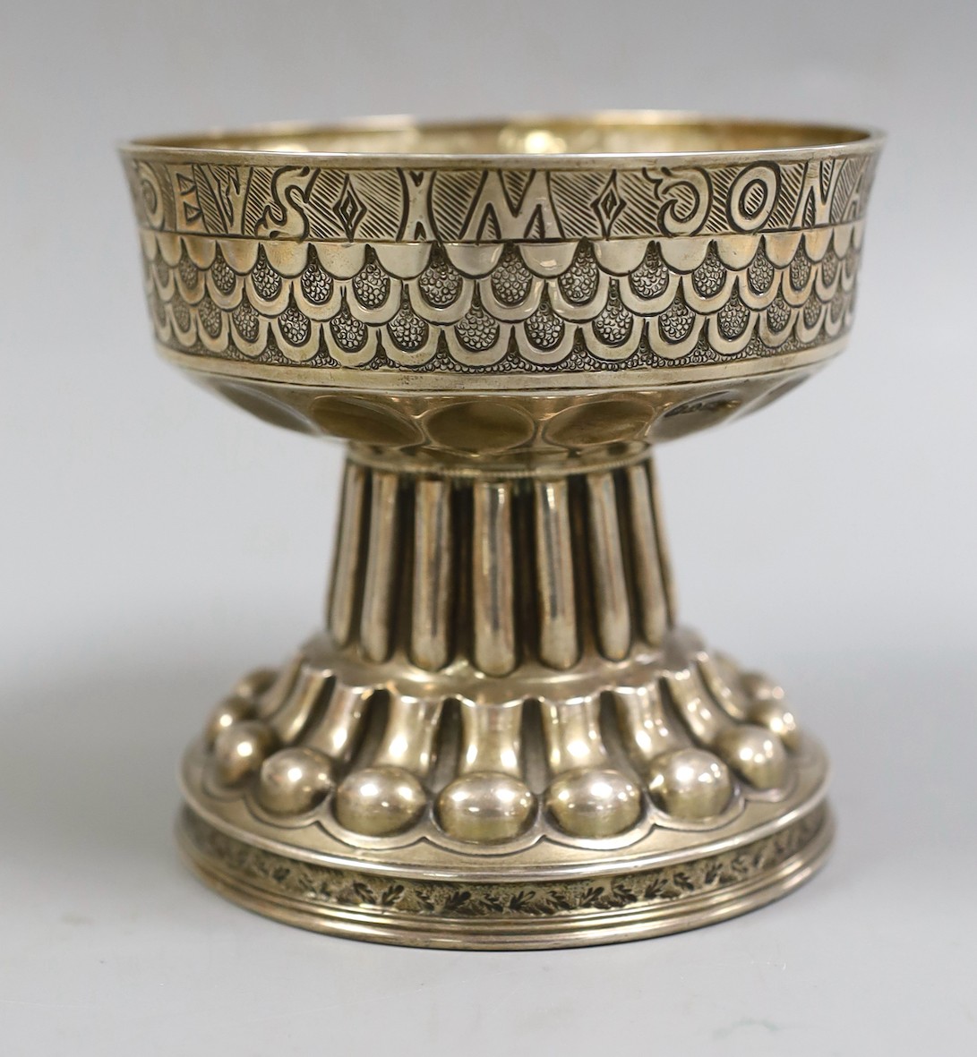 A George V silver replica of The Tudor (Holms) Cup, by Nathan & Hayes, Chester, 1910, the border with Latin inscription, height 11cm, 10.9oz.                                                                               