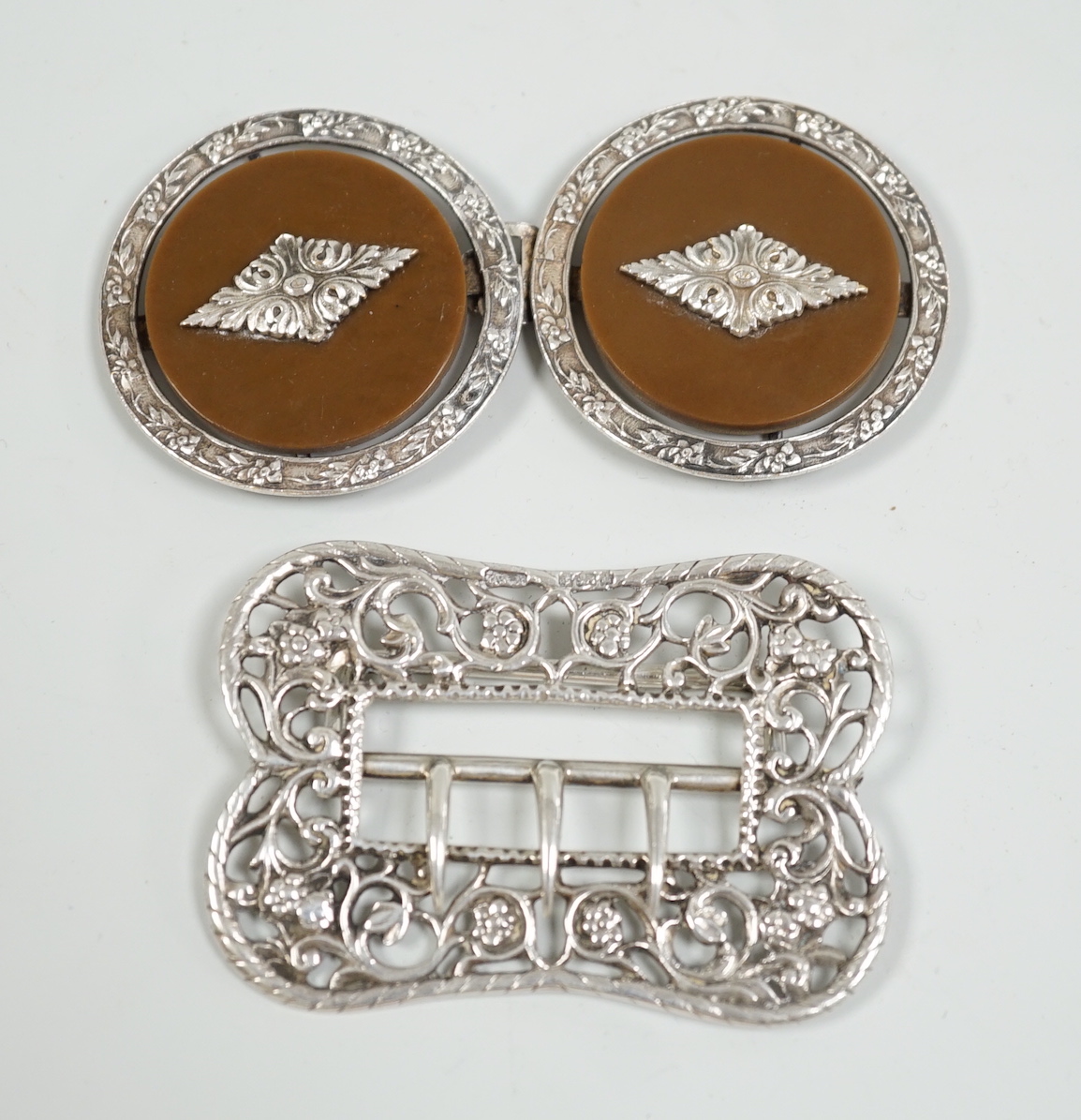 A Victorian silver belt buckle, H & A, Birmingham 1900, and a continental white metal mounted two piece belt buckle                                                                                                         
