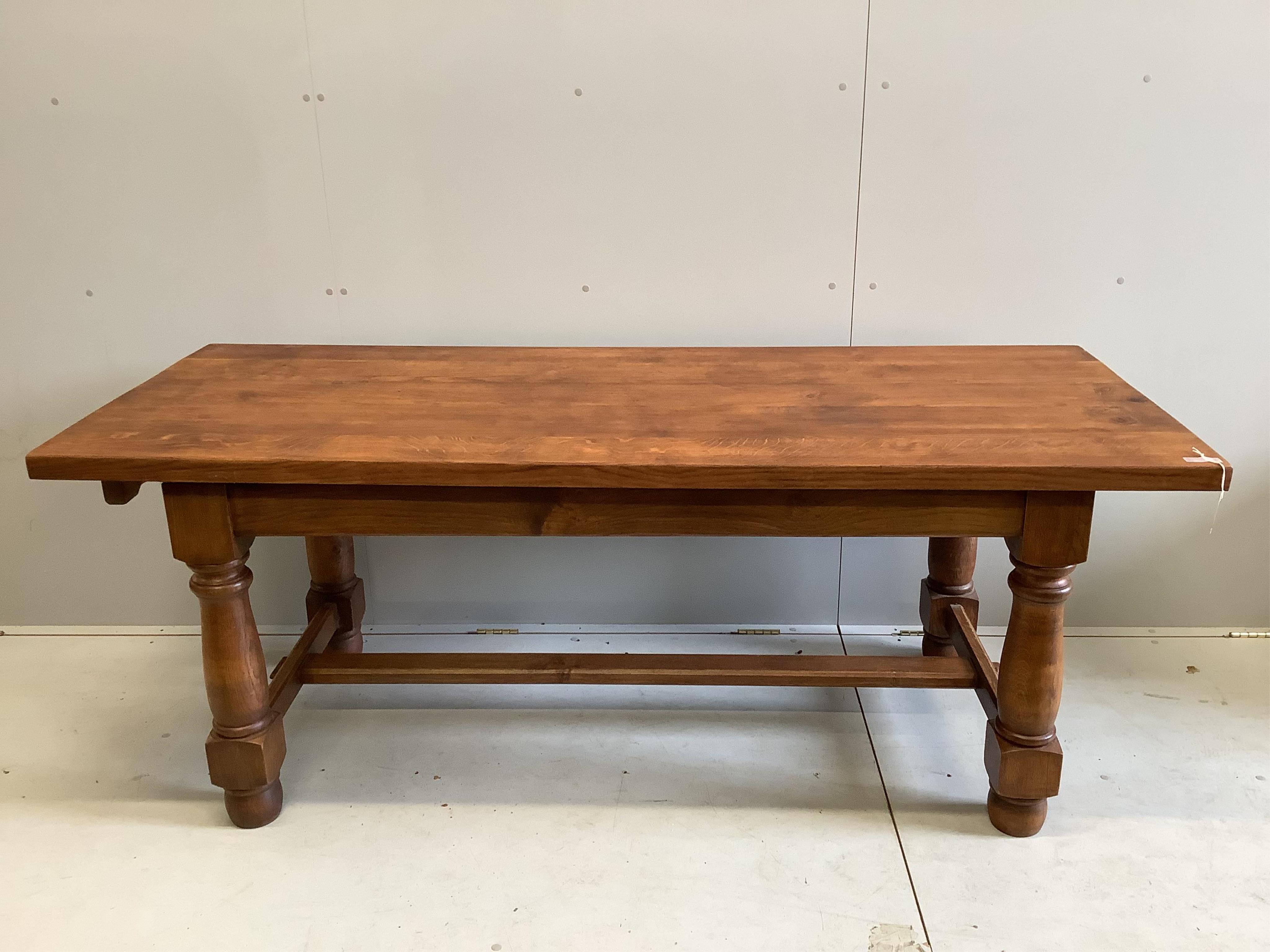 An 18th century style rectangular oak refectory dining table, (extending leaves added later), width 200cm, depth 79cm, height 77cm                                                                                          